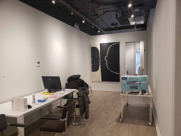 This image highlights the reception and consultation area of a modern beauty and massage spa, completed by a professional Toronto renovation company specializing in commercial interior renovations. The space features clean wall finishes, wood-look flooring, and an open ceiling concept with track lighting to create a contemporary and welcoming environment. Functional workspace planning allows for efficient client check-in, consultation, and daily operations. The minimalist layout and neutral tones enhance the overall calm and professional atmosphere, making it ideal for spa, wellness, and beauty clinic interiors across Toronto and the GTA.