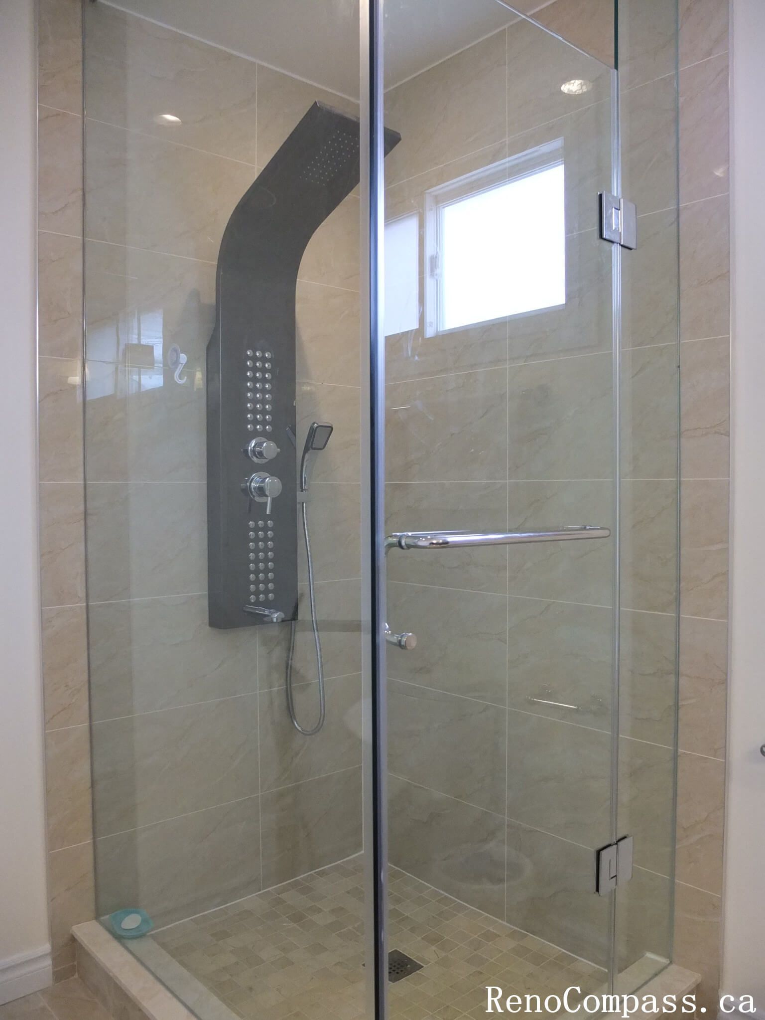 Bathroom renovation in North York showcasing a wood-tone vanity with integrated storage, quartz countertop, wall-mounted mirror, and modern lighting. This interior renovation highlights practical layout planning, neutral finishes, and long-term durability for Toronto residential homes.
