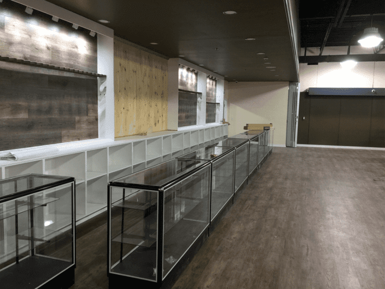 This outdoor equipment retail store renovation showcases a spacious open-concept layout with newly installed durable vinyl flooring, modern ceiling lighting, and custom display shelving. Reno Compass Inc. transformed the commercial space into a clean, functional, and customer-friendly retail environment, ideal for showcasing outdoor products while ensuring long-term durability and easy maintenance.