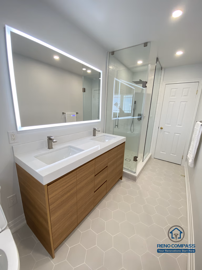 This image highlights a modern bathroom vanity renovation in Markham, featuring integrated drawers, a floating-style wood cabinet, and a sleek LED mirror. The design balances visual warmth with everyday practicality, completed by a trusted Toronto renovation company.