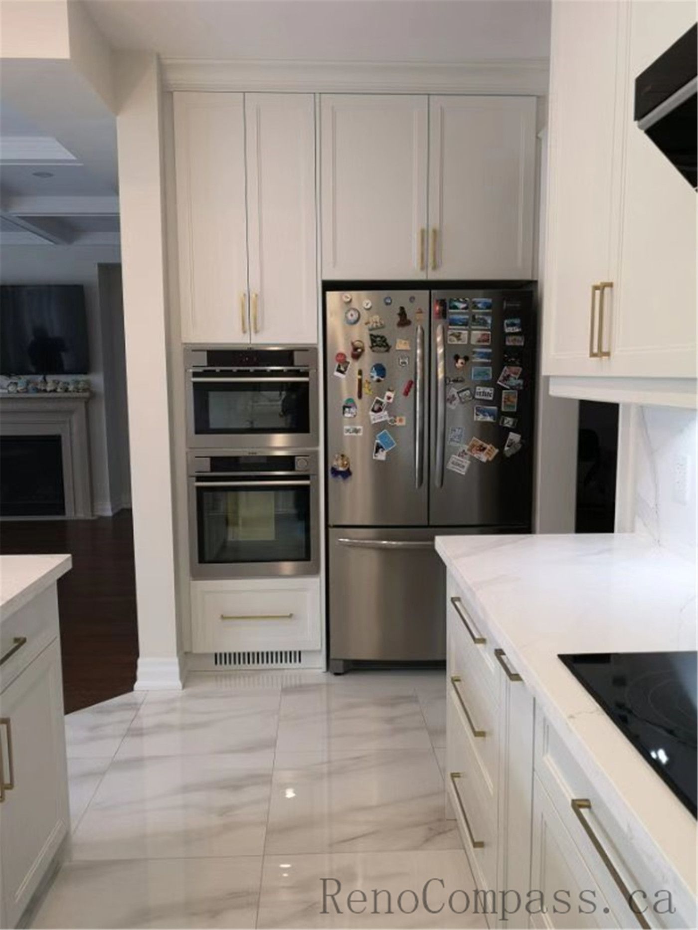 This Aurora kitchen renovation features custom white shaker cabinets with built-in oven and refrigerator layout, quartz countertops, and elegant brushed gold hardware. The spacious design improves workflow and storage while maintaining a clean and modern aesthetic. Completed by a professional Toronto renovation company focused on functional kitchen planning, high-quality finishes, and timeless interior design.