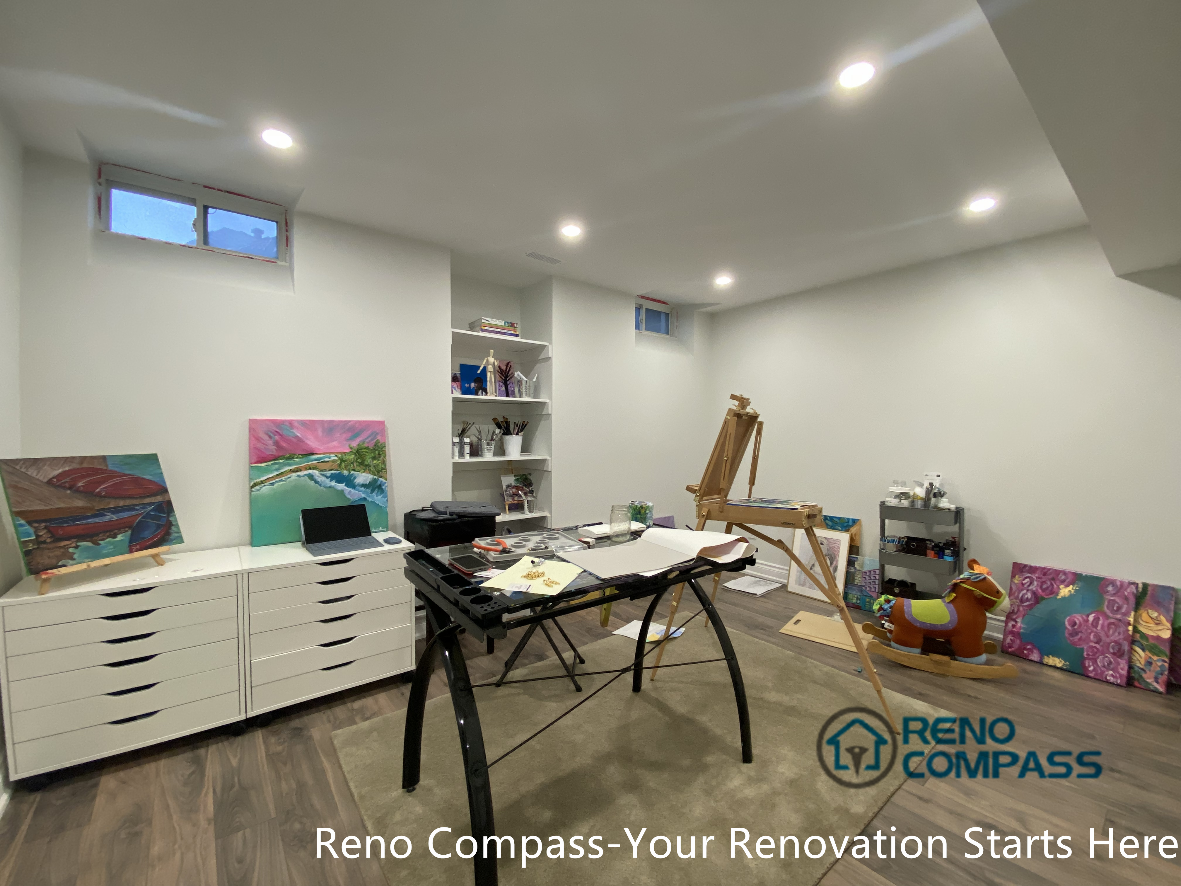 This image presents an open-concept basement living area renovation in Aurora. The layout emphasizes spatial flow and flexibility, allowing the basement to function comfortably as a family room or entertainment space while maintaining a clean and modern appearance.