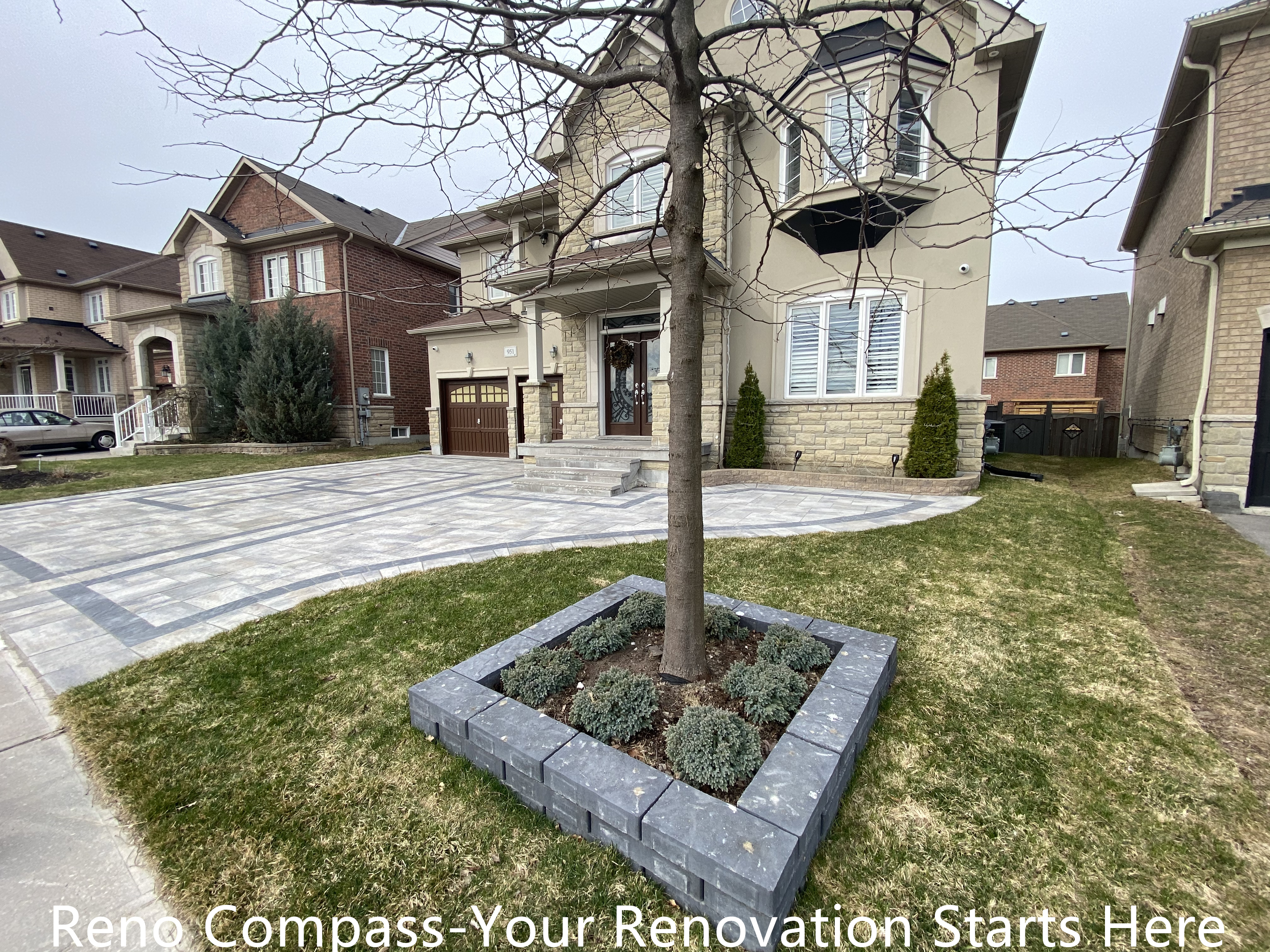 Front yard interlocking driveway and landscape renovation in Newmarket featuring a curved driveway layout, integrated tree planter, and clean edge detailing. The design balances hardscape and softscape elements, improving curb appeal, drainage performance, and overall exterior harmony. Completed by a professional Toronto renovation company specializing in high-quality residential outdoor renovations.