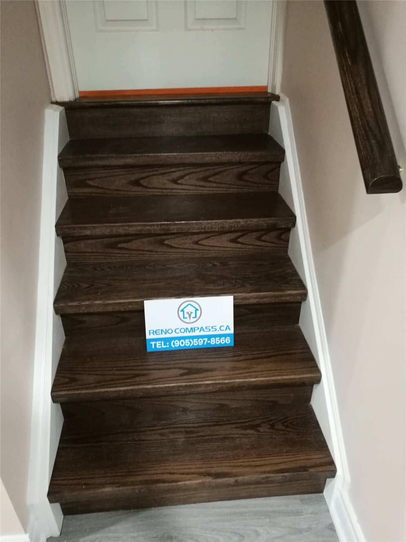This image highlights a hardwood staircase upgrade completed as part of a Newmarket interior renovation project. The stairs feature dark wood treads with clean white side trim, creating a strong contrast and a polished, modern finish. The renovation improves durability, safety, and visual continuity between floors. Completed by a professional Toronto renovation company, this staircase upgrade enhances daily functionality while adding long-term value to the home.