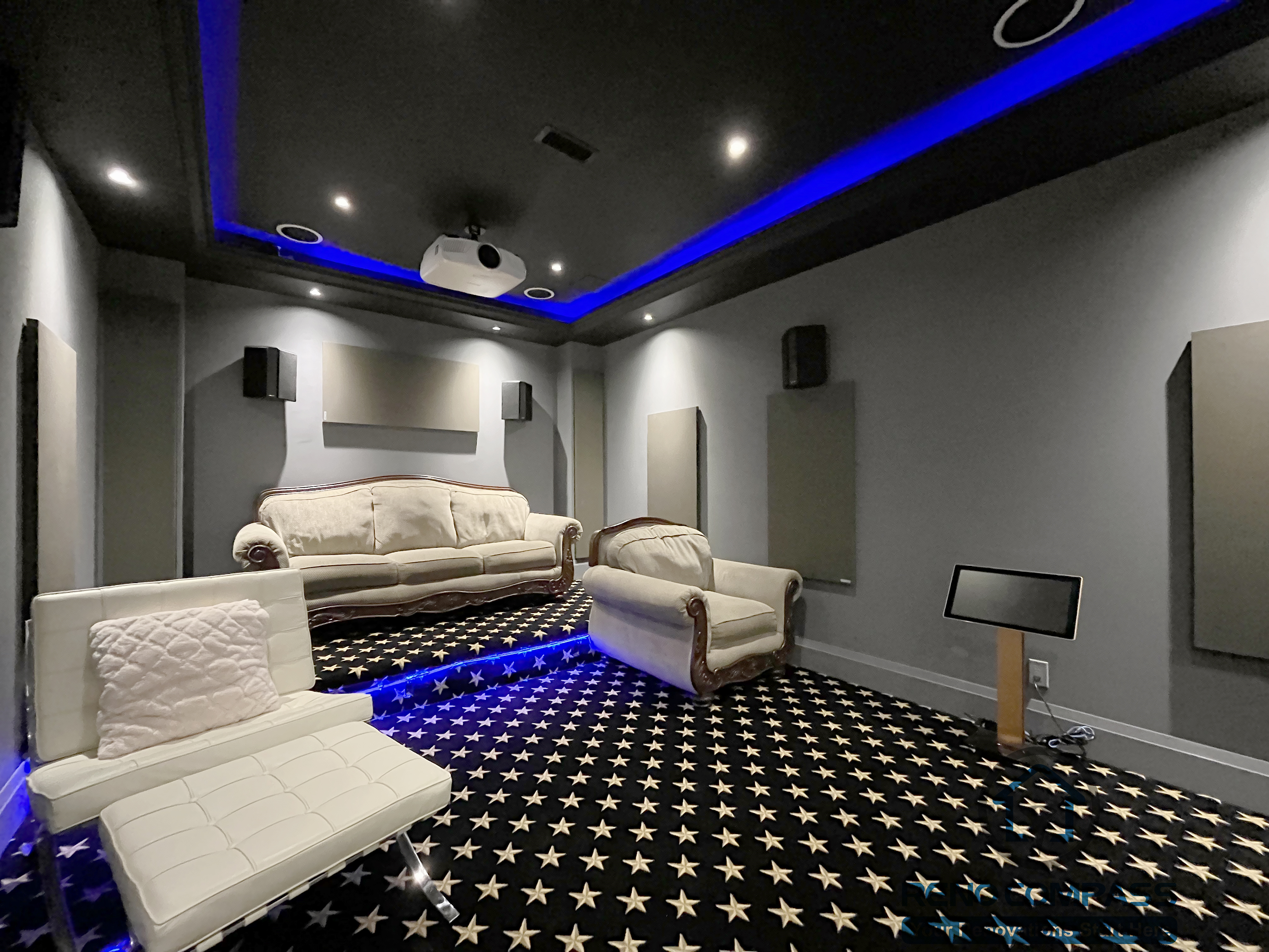 Home theatre basement renovation in Newmarket featuring acoustic wall panels, recessed lighting, custom ceiling design, and a comfortable seating layout for an immersive viewing experience.