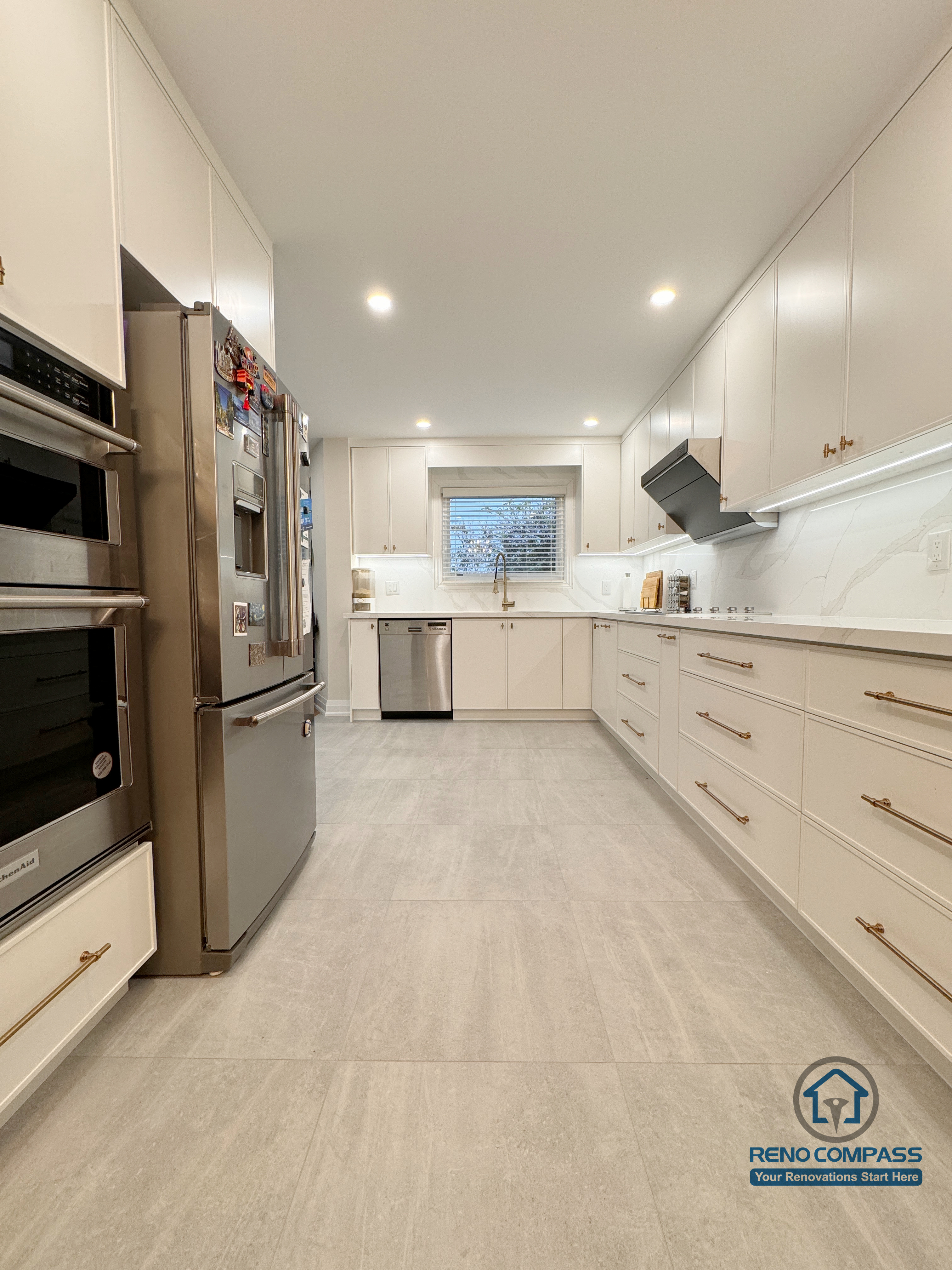 This Mississauga kitchen renovation features a refined galley-style layout with full-height custom cabinetry, integrated appliances, and streamlined storage. Light-toned finishes, quartz countertops, and recessed lighting enhance brightness while maintaining a clean, functional flow designed for everyday use.
