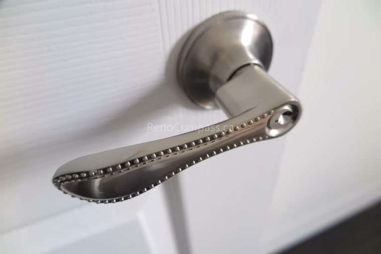 This close-up image highlights a brushed nickel door handle installed as part of a North York flooring renovation project. The clean finish and refined hardware design complement the surrounding interior elements, adding both functionality and visual consistency. As a professional Toronto Renovation Company, Reno Compass Inc. pays close attention to finishing details such as doors and hardware, ensuring every component aligns with the overall design and quality standards of the home.
