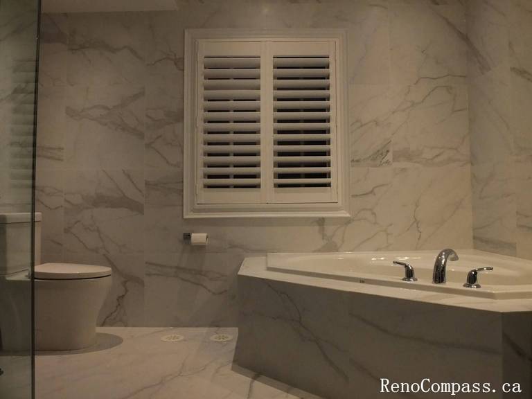 Transform your bathroom into a private spa. This Unionville renovation features a premium corner whirlpool tub with seamless marble tile integration, perfect for relaxation and modern style.