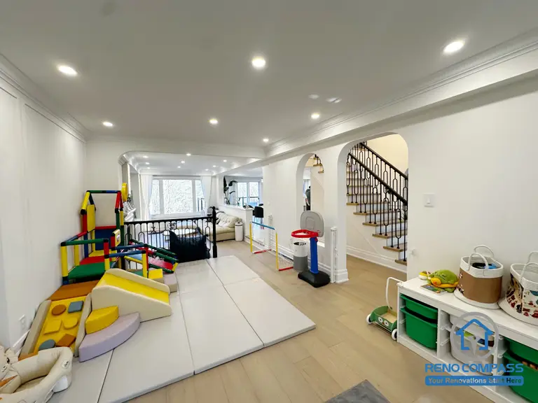 This Markham interior renovation was designed with everyday family life in mind, transforming the main living area into a flexible, child-friendly space that supports both play and relaxation. The open layout allows parents to maintain clear sightlines across the room while creating a safe and comfortable area for children’s activities.

Arched openings and consistent ceiling details help connect different zones of the home, while layered recessed lighting ensures the space remains bright and functional throughout the day. The combination of soft play areas and durable flooring makes the room adaptable as family needs evolve over time.

By balancing openness, safety, and long-term usability, this interior renovation creates a welcoming environment that works seamlessly for modern family living in Markham.