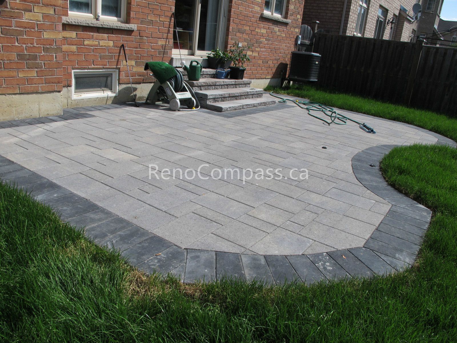 This Vaughan outdoor landscaping project features a professionally installed interlocking stone patio with a custom border design and step integration. The clean layout enhances the backyard’s functionality, creating a spacious and durable outdoor living area ideal for relaxation and gatherings. Reno Compass delivers precise stone installation, modern backyard upgrades, and long-lasting landscaping solutions for Vaughan homeowners.