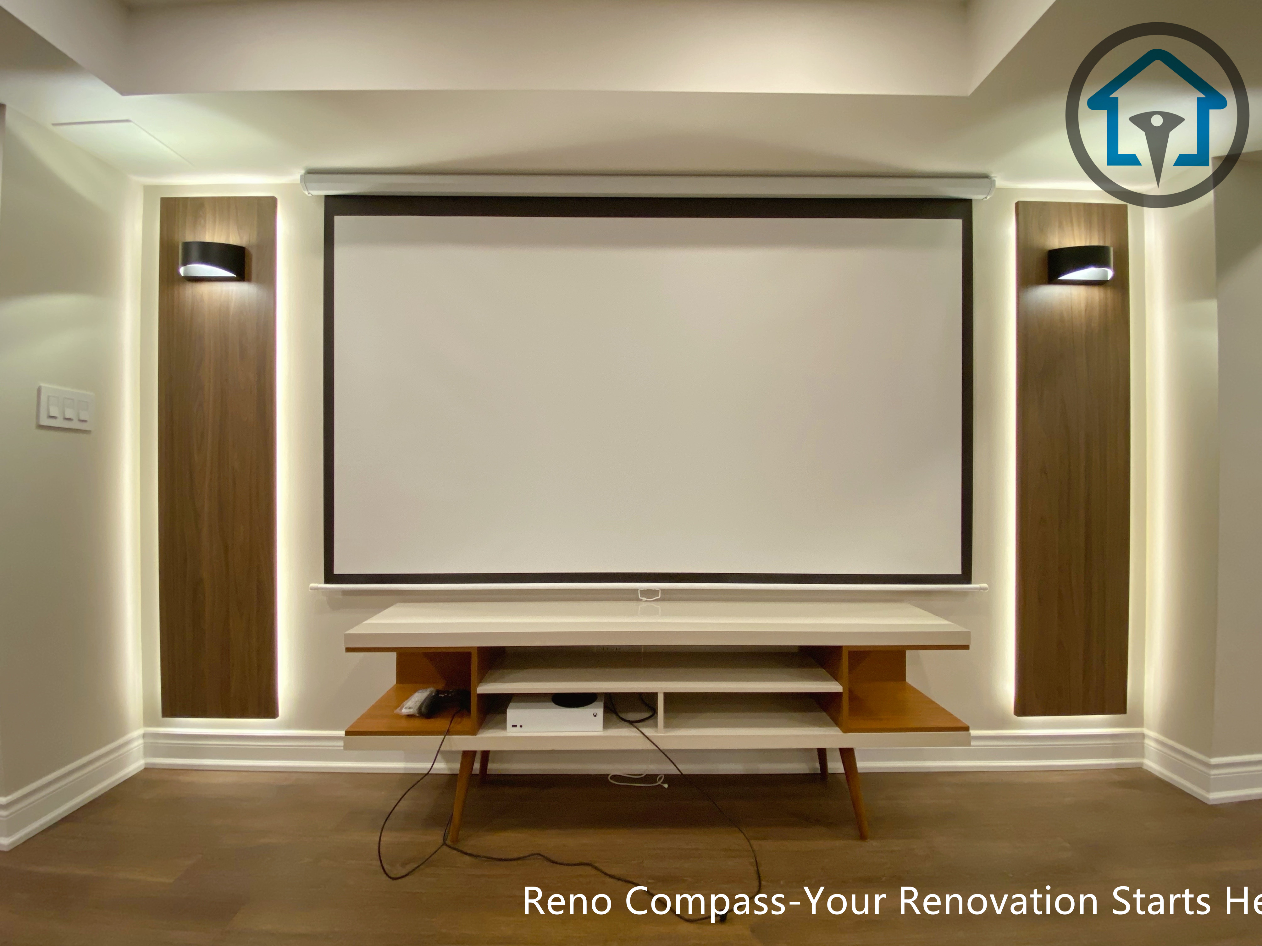 Basement media area renovation in Markham with a projector setup, decorative wood panels, integrated backlighting, and wall sconces creating a visual focal point.