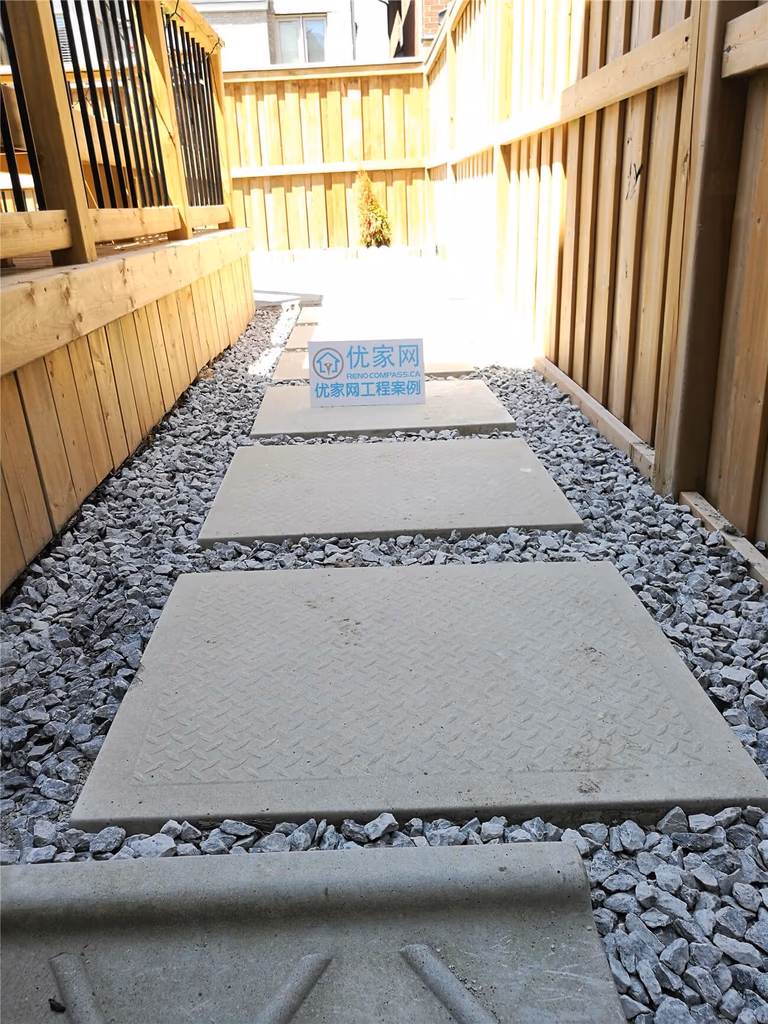This Stouffville landscaping renovation features a clean and modern backyard walkway design using large concrete stepping stones set in decorative gravel. The narrow side yard was transformed into a functional and low-maintenance pathway, improving drainage, accessibility, and overall curb appeal. Completed by a professional Toronto landscaping and renovation team, the project enhances outdoor usability while maintaining a natural and minimalist aesthetic suitable for modern residential homes.