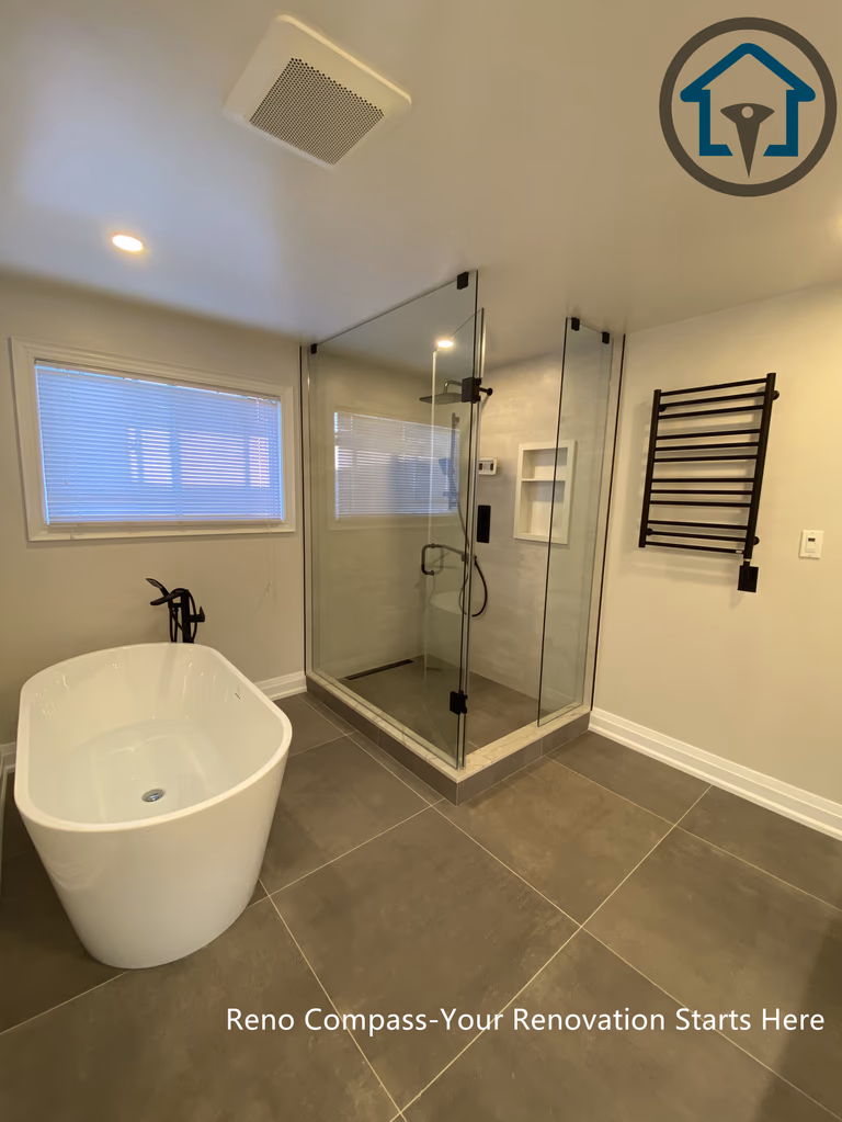 Spacious bathroom renovation in Markham featuring a frameless glass walk-in shower, freestanding soaking tub, large-format floor tiles, and modern matte black fixtures. The layout emphasizes comfort, functionality, and a clean contemporary aesthetic completed by a professional Toronto renovation company.