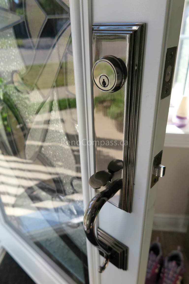 Close-up detail of newly installed double entry door hardware in a New market home, featuring modern black handles and secure locking systems paired with decorative privacy glass panels. Completed by a professional Toronto Renovation Company, this door upgrade enhances both security and visual appeal while adding a refined, high-end finish to the home’s main entrance.