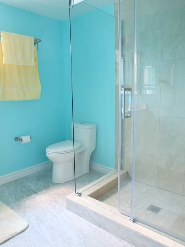 This bathroom renovation in Richmond Hill features a clean and modern interior design with a frameless glass shower enclosure, updated shower base, and a compact yet functional layout. Soft wall colors combined with bright lighting enhance the sense of space, while the upgraded toilet and tiled shower area improve both comfort and daily usability. Completed as part of a full interior renovation, this project reflects professional workmanship and practical design solutions by an experienced Toronto renovation company serving Richmond Hill homeowners.