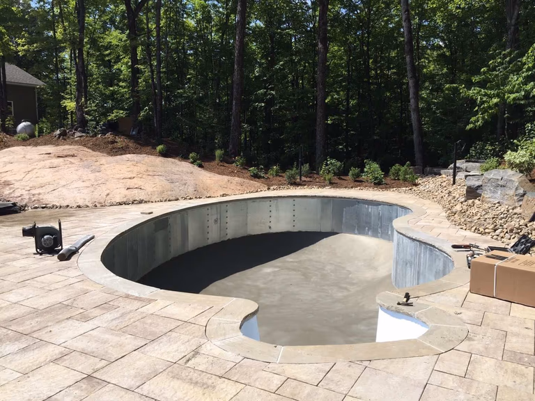 Custom backyard swimming pool construction in Toronto featuring professional steel pool structure installation and foundation preparation. This stage highlights precise pool framing, base leveling, and site grading to ensure long-term durability and structural stability for a high-quality residential swimming pool project.