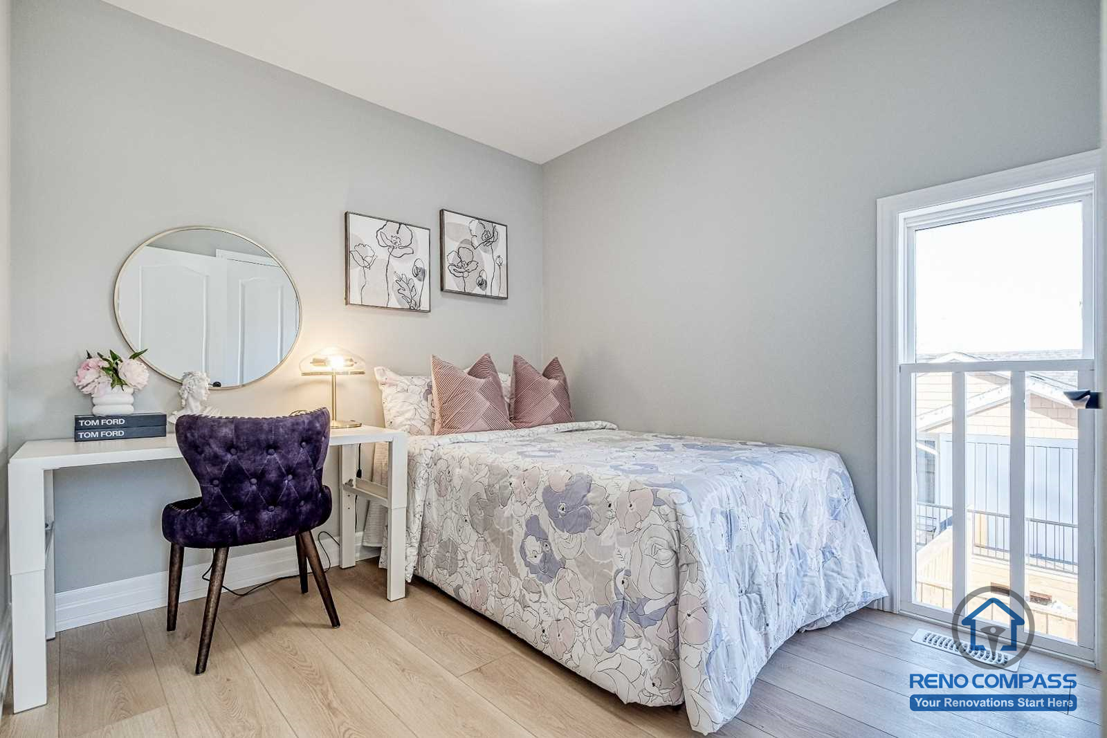 This Georgian interior renovation features a bright secondary bedroom with a balcony door, light wood flooring, and a compact vanity workspace. Soft colors and thoughtful layout create a comfortable and functional private space, completed by a Toronto renovation company.