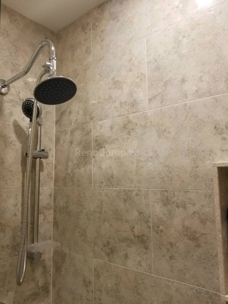 This Markham bathroom renovation features a newly installed rain shower system with handheld shower attachment, paired with modern wall tile installation for a clean and elegant finish. The upgraded shower area offers improved functionality, better water flow control, and a spa-like experience. As part of a full bathroom remodel including new flooring and vanity, the refreshed shower enhances comfort, durability, and overall modern design.