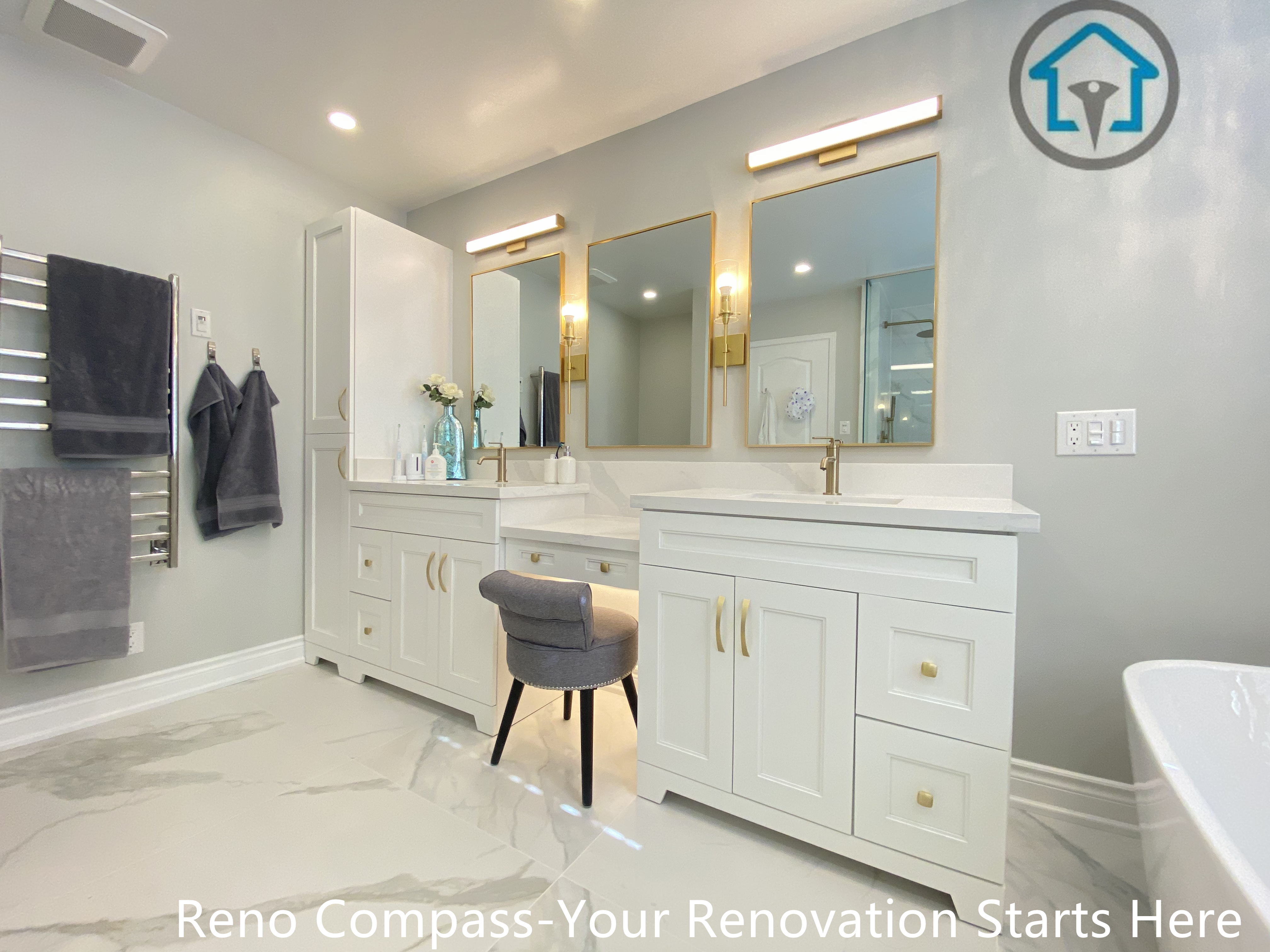This Mississauga bathroom renovation highlights a custom double vanity with classic shaker-style cabinetry and integrated storage. The space features dual mirrors with warm gold-tone frames, matching wall-mounted vanity lighting, and marble-look porcelain flooring that enhances brightness and visual continuity. Soft grey wall tones balance the crisp white cabinetry, creating a calm and refined atmosphere. The layout was designed to support shared daily use while maintaining symmetry, comfort, and long-term durability through high-quality finishes and precise installation.