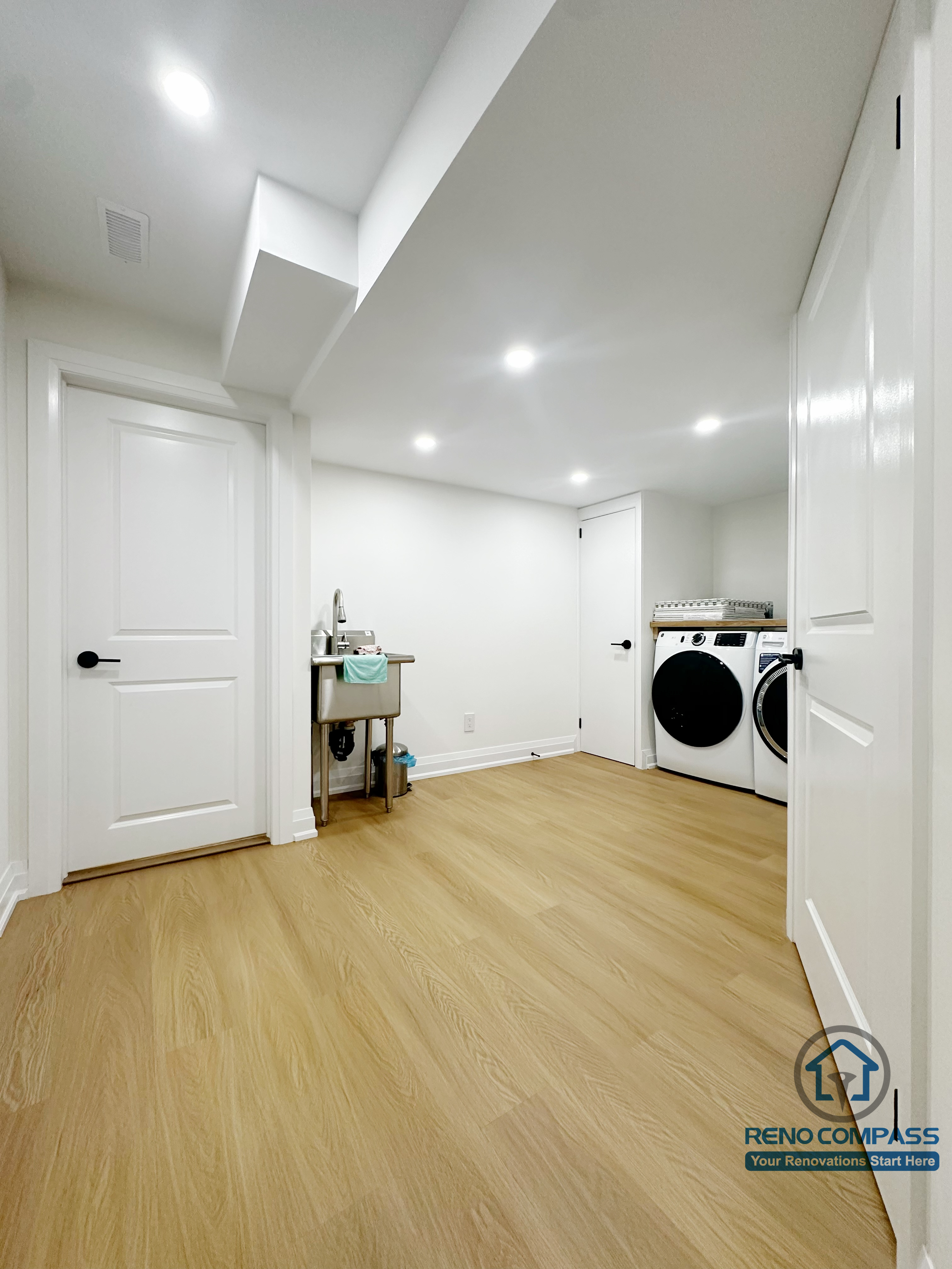 Finished basement laundry and utility space in Markham featuring recessed lighting, moisture-resistant flooring, and a clean, functional layout. Designed for long-term durability and everyday convenience within a full basement renovation project.