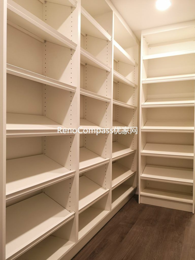 Custom walk-in basement storage room renovation in Richmond Hill featuring full-height built-in shelving, durable flooring, and bright recessed lighting. Completed by Reno Compass Inc., this organized storage space maximizes functionality and home value.