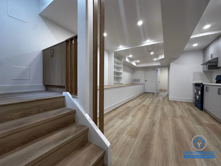 This basement unit layout showcases the connection between the staircase access and the open living space in a Toronto legal 3-unit conversion. The design clearly separates levels while maintaining functional flow, creating an independent and fully livable rental unit.