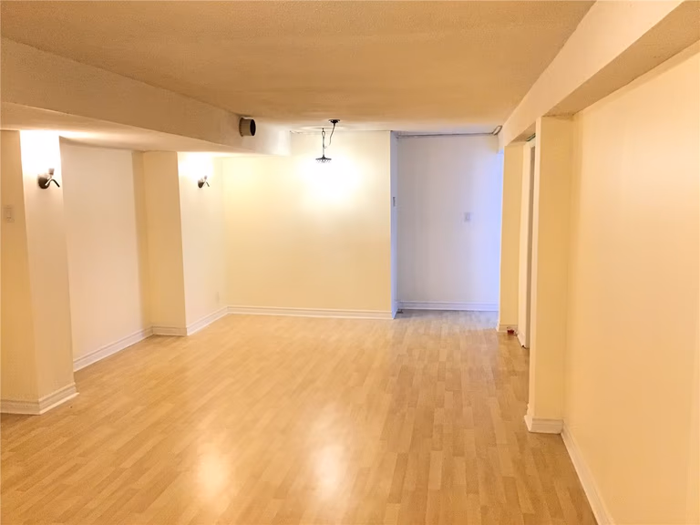 This Whitby basement renovation project features a bright and spacious open-concept layout with newly installed laminate flooring and soft neutral wall tones. The clean design maximizes usable space, making it ideal for a family entertainment area, home office, or recreational room. Professional lighting installation and smooth wall finishing create a warm and inviting atmosphere, enhancing both comfort and property value.