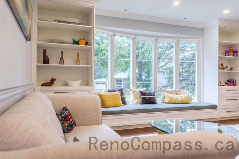 This North York interior renovation features a bright and elegant living space with custom built-in shelving and a beautifully designed bay window bench. The built-in seating area creates a cozy reading nook while maximizing natural light and storage. Paired with soft neutral tones, recessed lighting, and modern furnishings, the room offers both comfort and functionality. Completed by a professional Toronto renovation company, this project showcases thoughtful craftsmanship and timeless interior design that enhances everyday living.