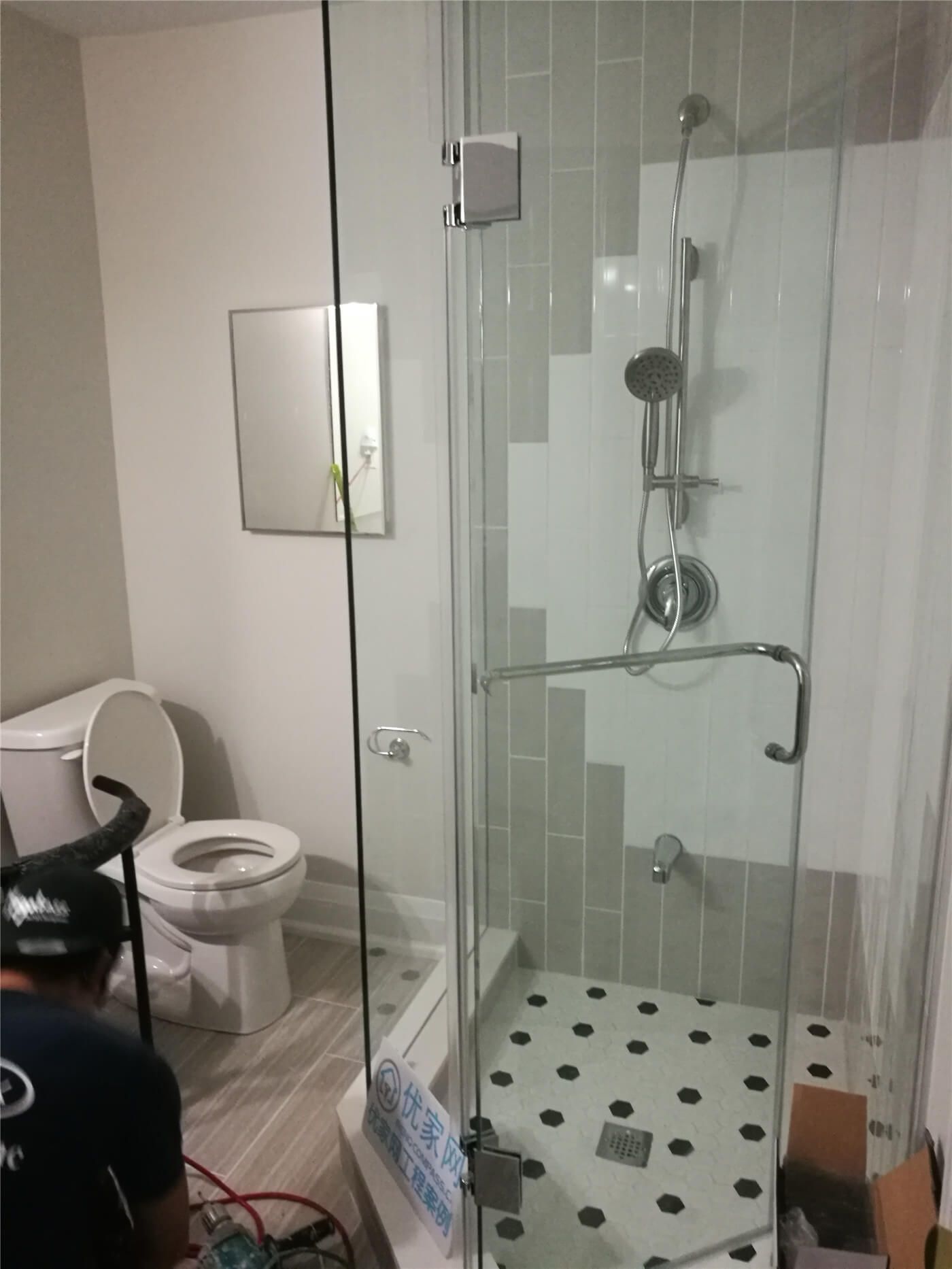This Markham basement bathroom renovation showcases a modern frameless glass shower enclosure with updated fixtures, new floor tiles, and a refreshed toilet area. Completed by Reno Compass Inc., the upgrade enhances functionality, durability, and a clean contemporary look for the basement living space.