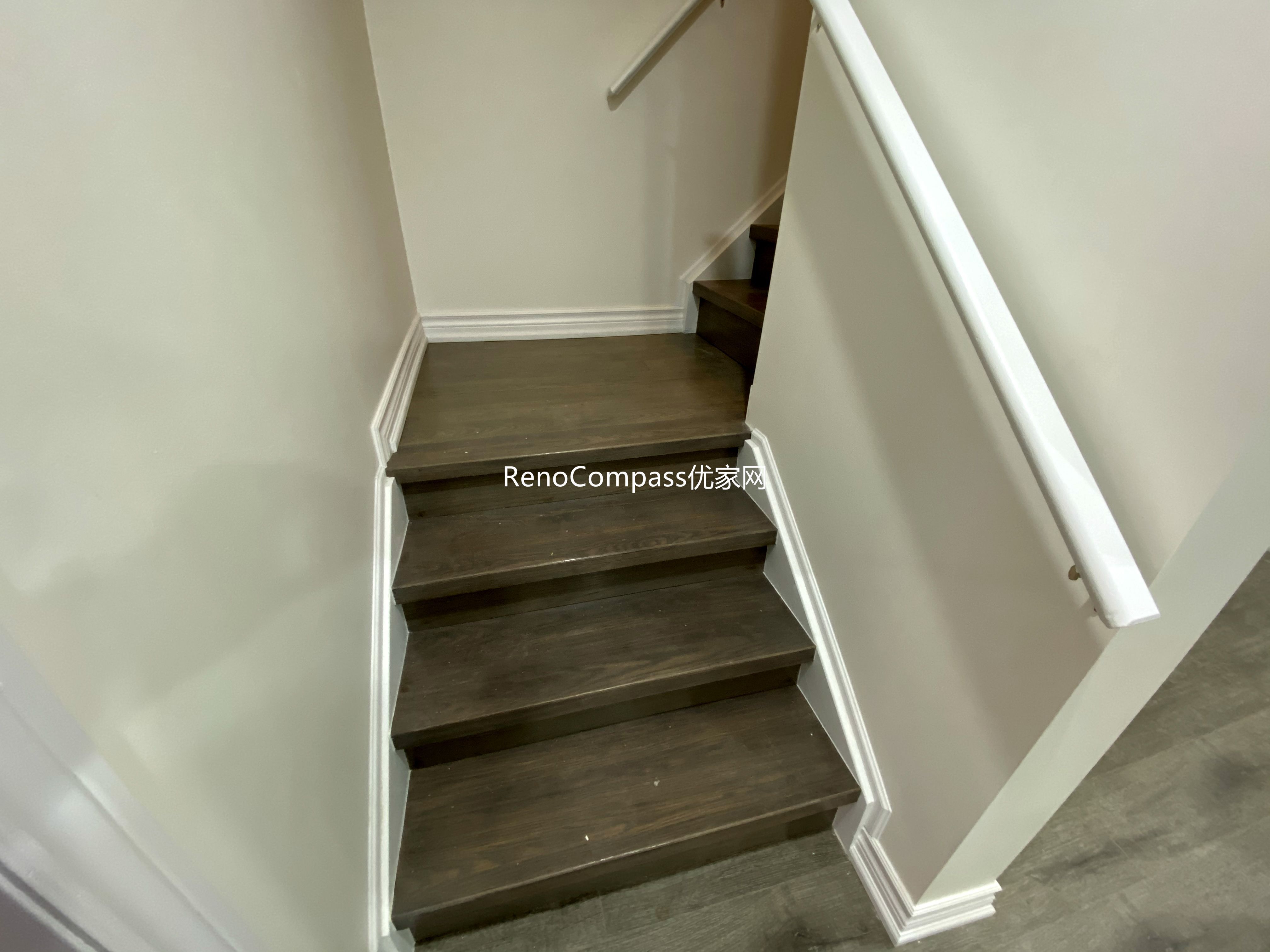 Basement staircase renovation in Richmond Hill featuring modern dark wood steps, upgraded handrails, and clean wall finishes. Completed by a professional Toronto renovation company, this basement upgrade enhances safety, durability, and visual appeal while creating a seamless transition between main floor and finished basement living space.
