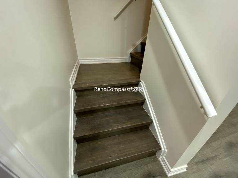 Basement staircase renovation in Richmond Hill featuring modern dark wood steps, upgraded handrails, and clean wall finishes. Completed by a professional Toronto renovation company, this basement upgrade enhances safety, durability, and visual appeal while creating a seamless transition between main floor and finished basement living space.