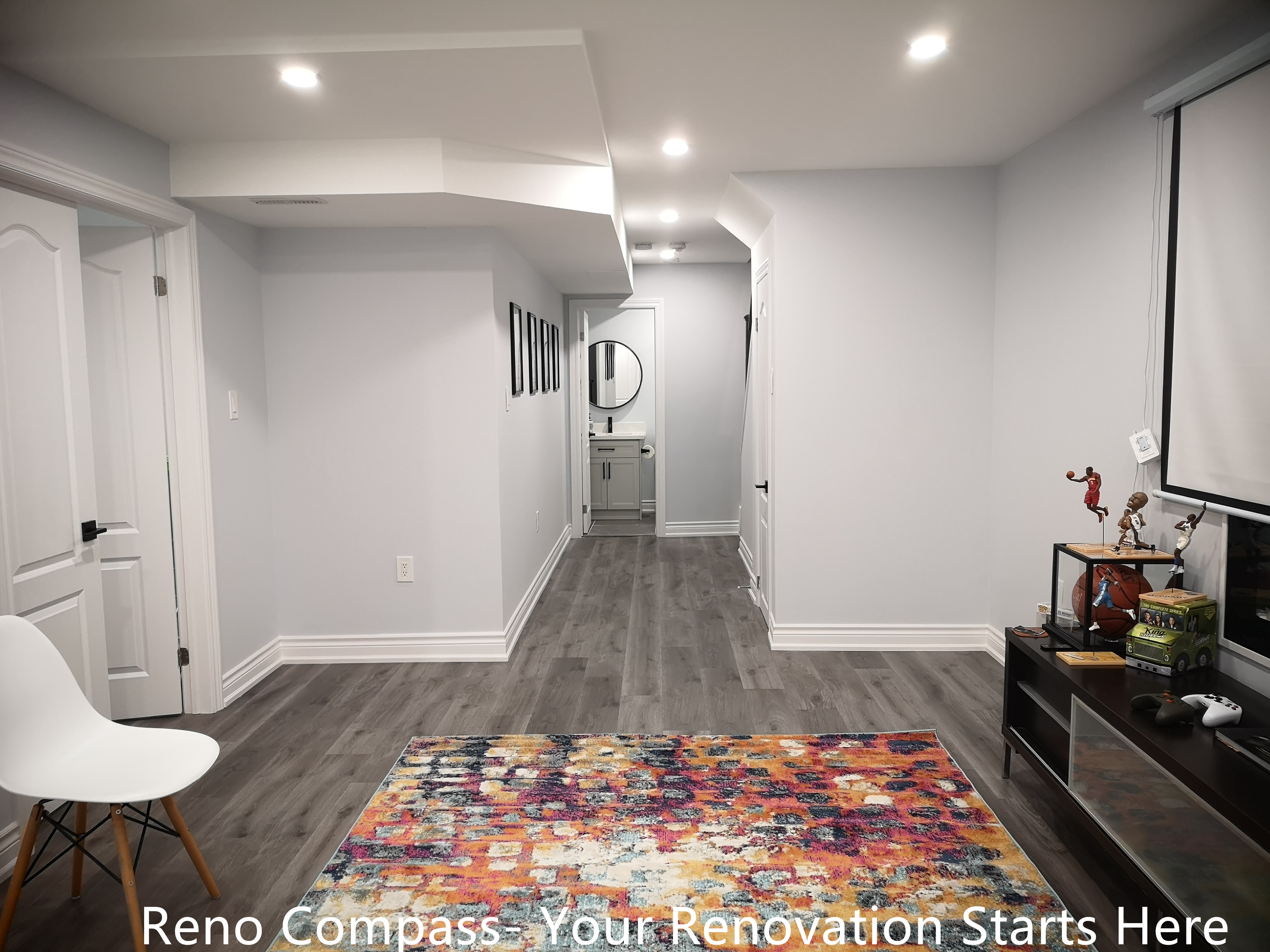 This Whitby basement renovation features a newly finished open-concept layout designed to improve brightness and everyday usability. Durable wood-look flooring is installed throughout the space, creating visual continuity while ensuring easy maintenance. Neutral wall colors and recessed lighting enhance the sense of openness, making the basement suitable for a family room, recreation area, or multi-purpose living space.