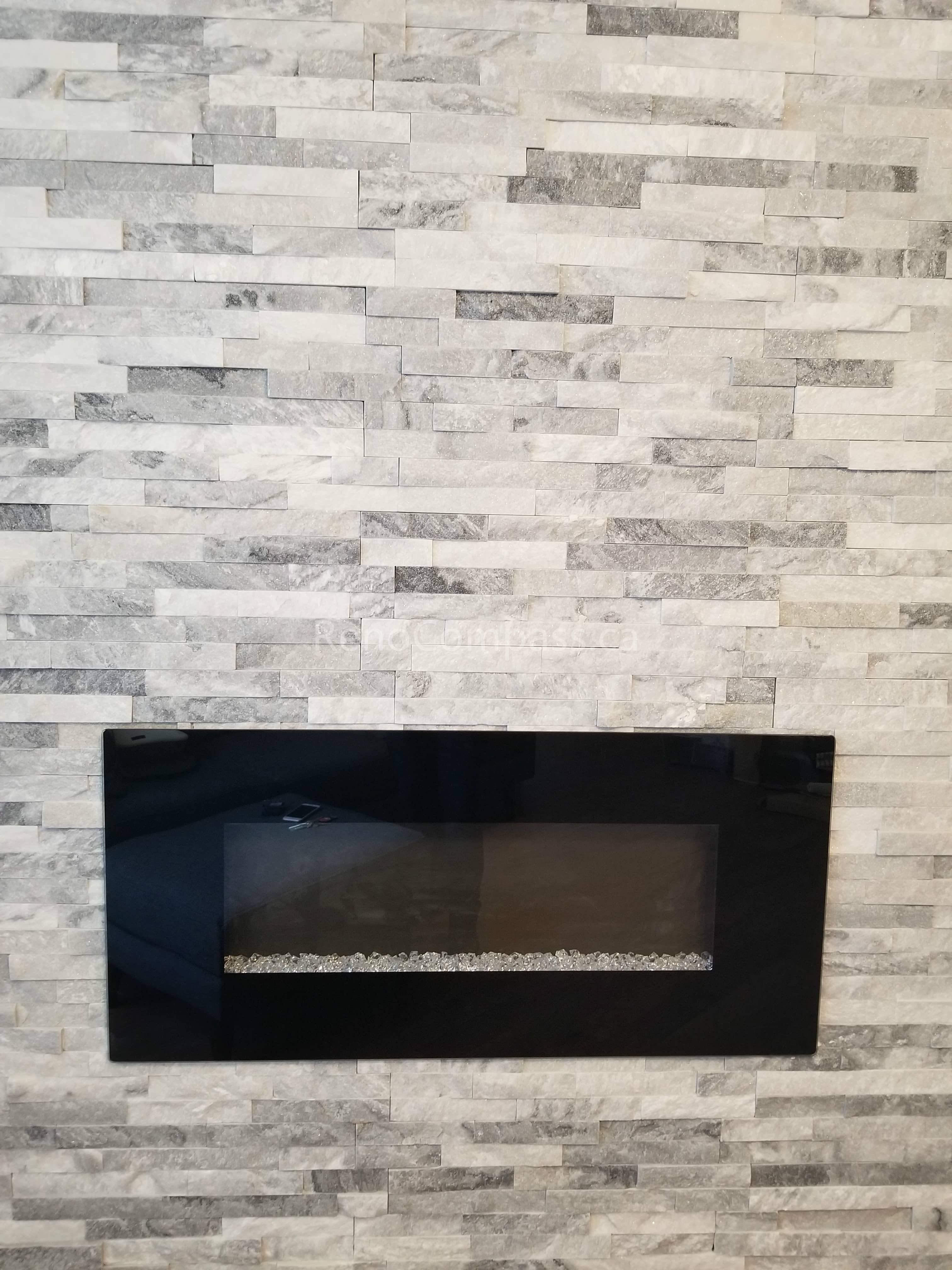 This Mississauga interior renovation features a contemporary stone feature wall paired with a sleek linear electric fireplace, creating a warm and elegant focal point for the living space. The stacked stone texture adds depth and luxury, while the built-in fireplace enhances both comfort and visual appeal.
Completed by Reno Compass Inc., this modern interior upgrade blends functionality, style, and high-quality craftsmanship to elevate the home’s overall atmosphere and property value.
