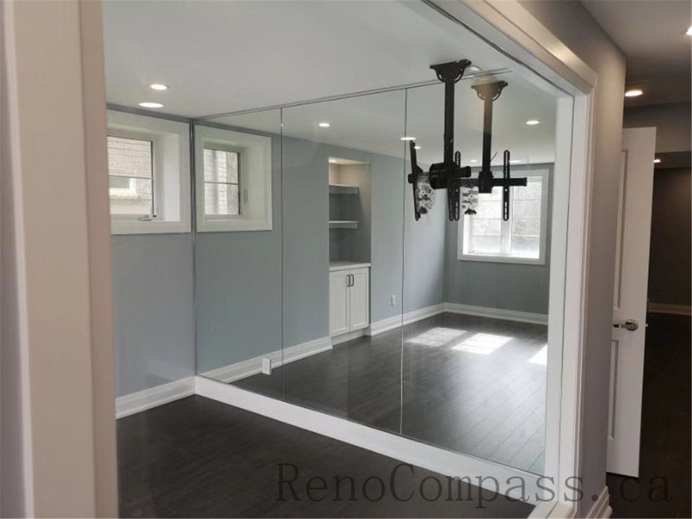 A beautifully remodeled basement media room built with custom cabinetry, accent lighting, and functional layout. Reno Compass designed this Aurora renovation for comfort and entertainment.