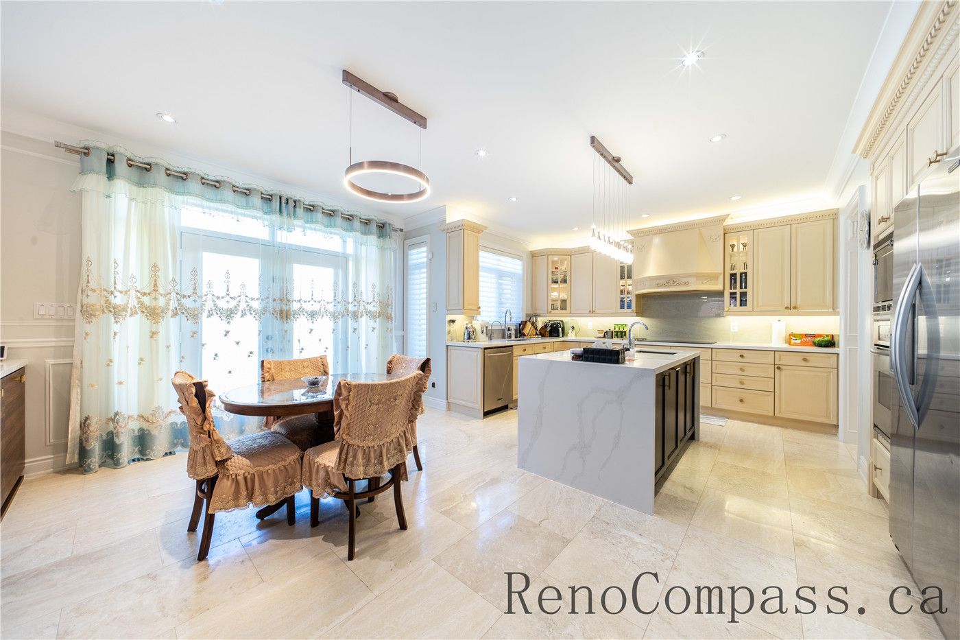 This Richmond Hill entire house interior renovation features a spacious luxury kitchen with a large central island, quartz countertops, and custom cabinetry. Modern pendant lighting and built-in appliances enhance both functionality and style, while the open-concept layout connects seamlessly to the living area. Designed for daily living and entertaining, this bright and elegant kitchen renovation was completed by a professional Toronto renovation company focused on craftsmanship, efficiency, and timeless design.