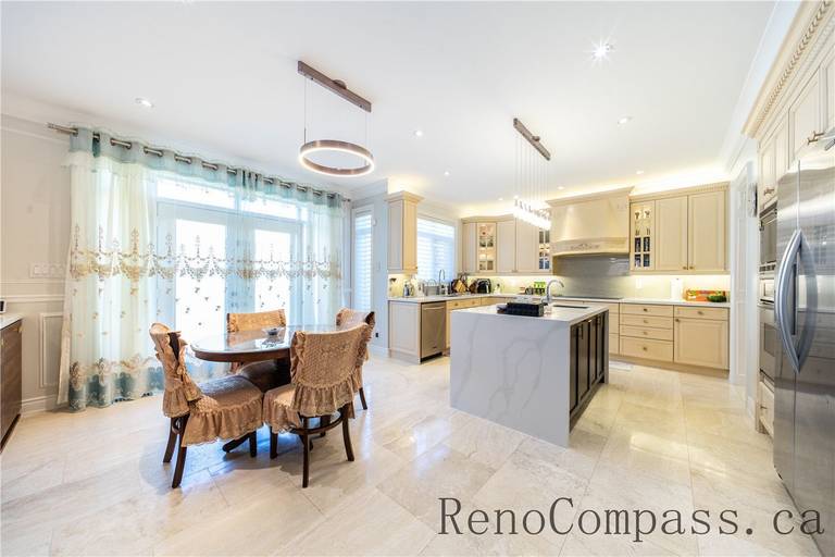 This Richmond Hill entire house interior renovation features a spacious luxury kitchen with a large central island, quartz countertops, and custom cabinetry. Modern pendant lighting and built-in appliances enhance both functionality and style, while the open-concept layout connects seamlessly to the living area. Designed for daily living and entertaining, this bright and elegant kitchen renovation was completed by a professional Toronto renovation company focused on craftsmanship, efficiency, and timeless design.