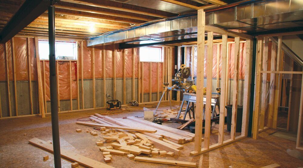 This image captures the interior framing and structural construction phase of a Toronto office commercial design project. The photo shows exposed wall studs, ceiling joists, and mechanical ductwork prior to drywall installation, highlighting the early-stage build-out process. Proper framing, insulation preparation, and layout planning ensure the office space meets structural, functional, and code requirements. This stage reflects the careful planning and construction expertise of a professional Toronto commercial renovation company.