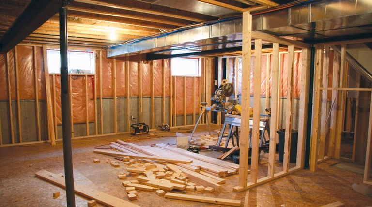 This image captures the interior framing and structural construction phase of a Toronto office commercial design project. The photo shows exposed wall studs, ceiling joists, and mechanical ductwork prior to drywall installation, highlighting the early-stage build-out process. Proper framing, insulation preparation, and layout planning ensure the office space meets structural, functional, and code requirements. This stage reflects the careful planning and construction expertise of a professional Toronto commercial renovation company.