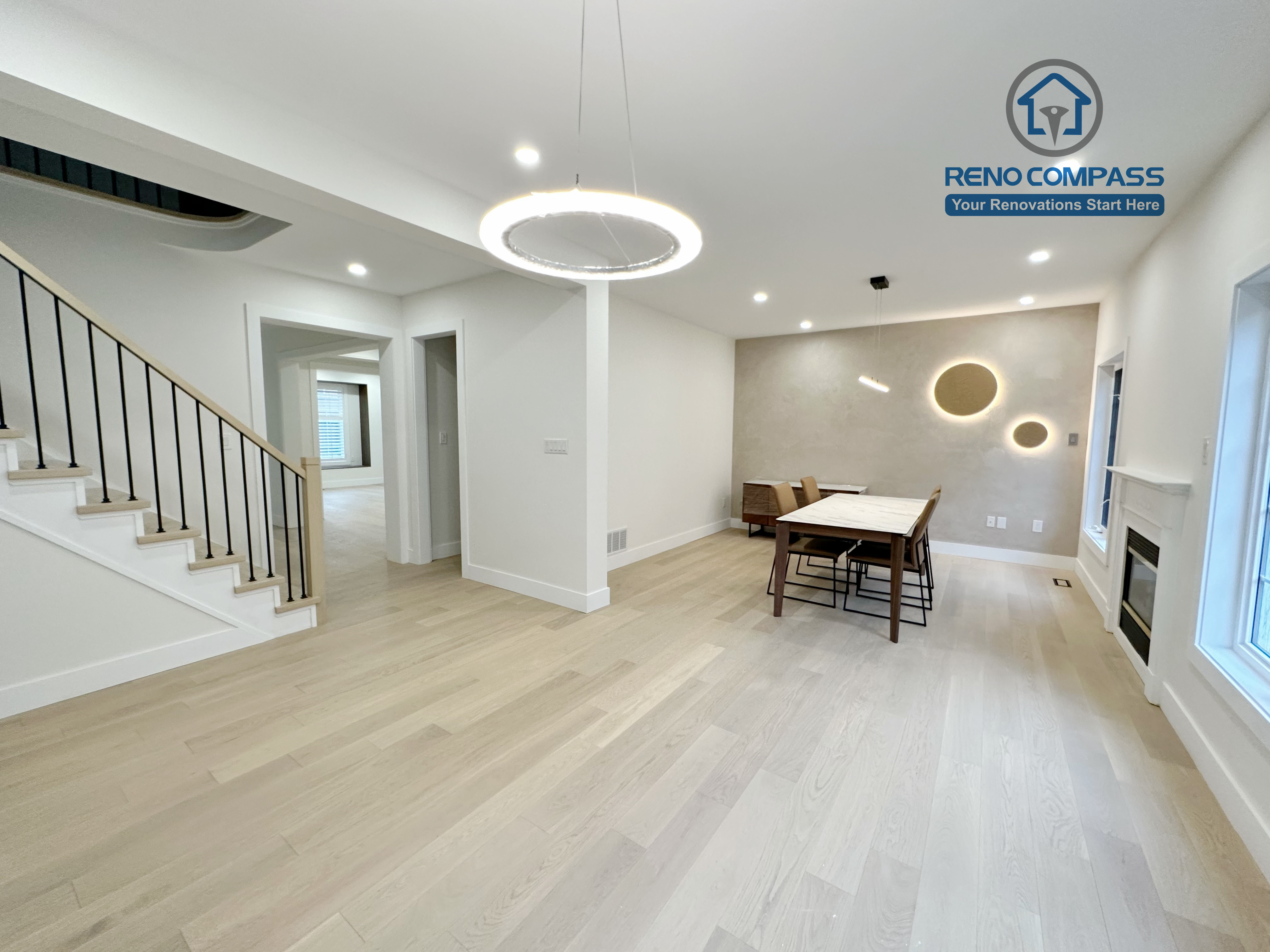Open-concept living and dining area in a Richmond Hill home featuring light-tone hardwood flooring and a modern staircase renovation, creating a bright, seamless, and contemporary interior space.