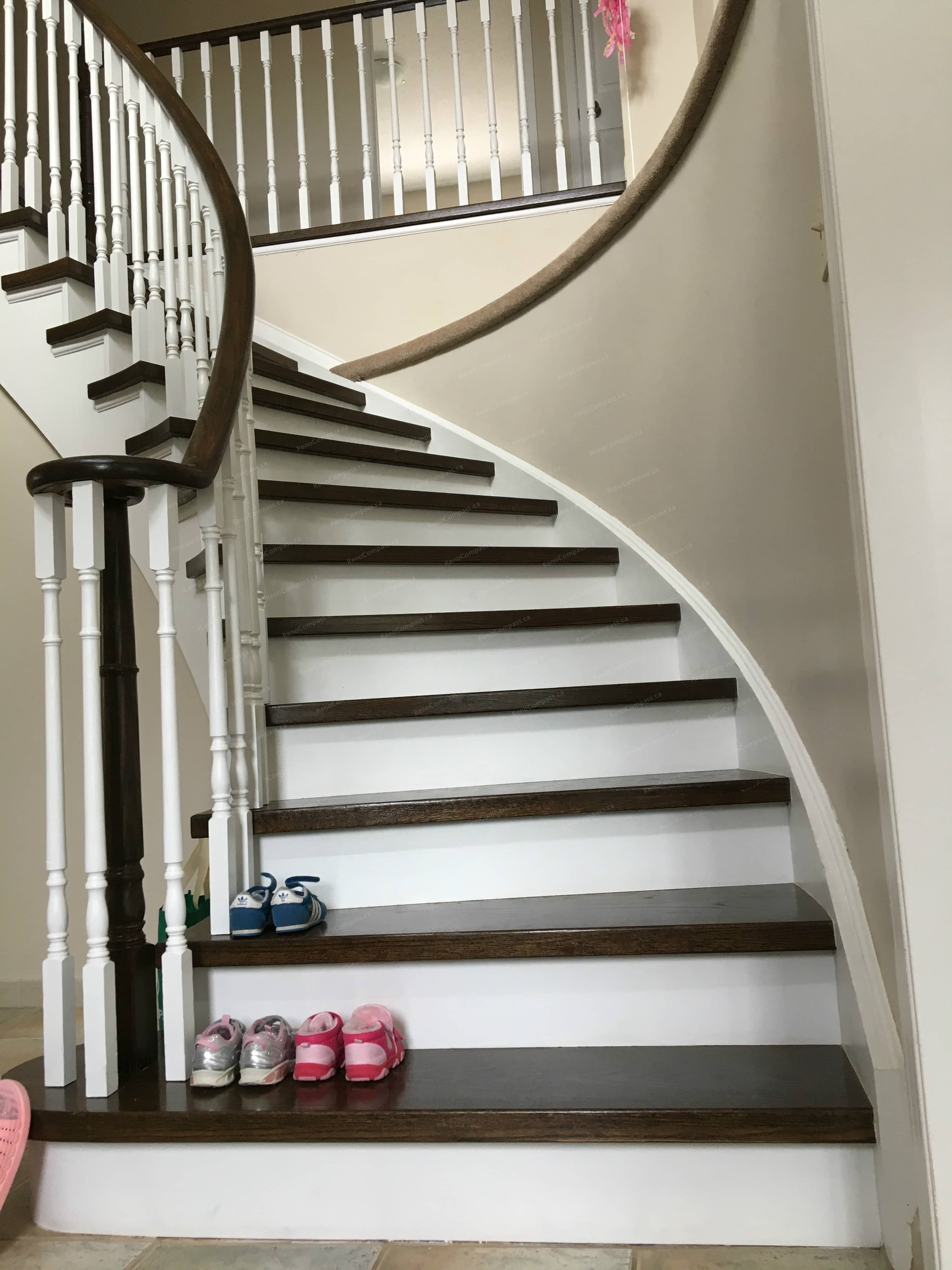 This Oakville interior renovation features a beautifully refinished curved staircase with rich wood stair treads, white risers, and classic railings. The updated staircase design enhances both safety and visual appeal, creating a clean and elegant transition between floors. Combining modern finishes with timeless craftsmanship, this staircase renovation adds value and sophistication to the home while reflecting high-quality interior renovation work in Oakville.