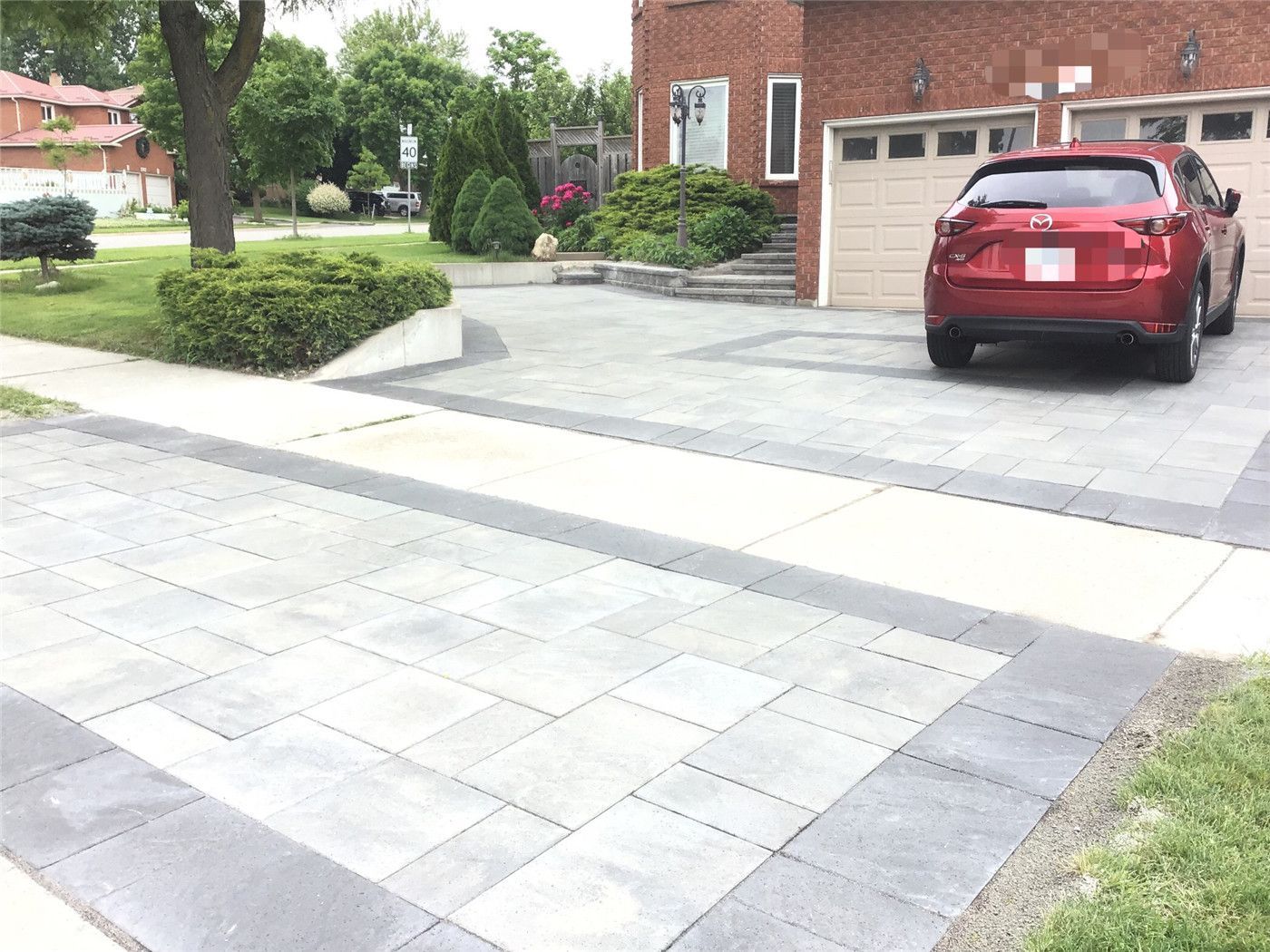 A complete front yard landscaping renovation in Mississauga featuring a modern interlocking driveway, clean border detailing, and a spacious parking layout. This project enhances curb appeal, improves functionality, and delivers a durable, low-maintenance outdoor surface designed for long-term use.