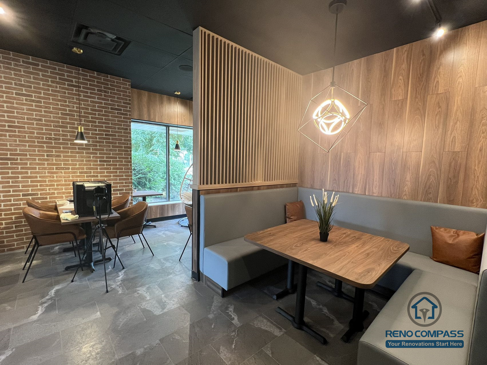 This Mississauga restaurant renovation features a semi-private booth seating area with custom millwork, wood panel accents, and integrated lighting. The layout creates a comfortable dining environment that enhances privacy while maintaining an open and modern restaurant interior.