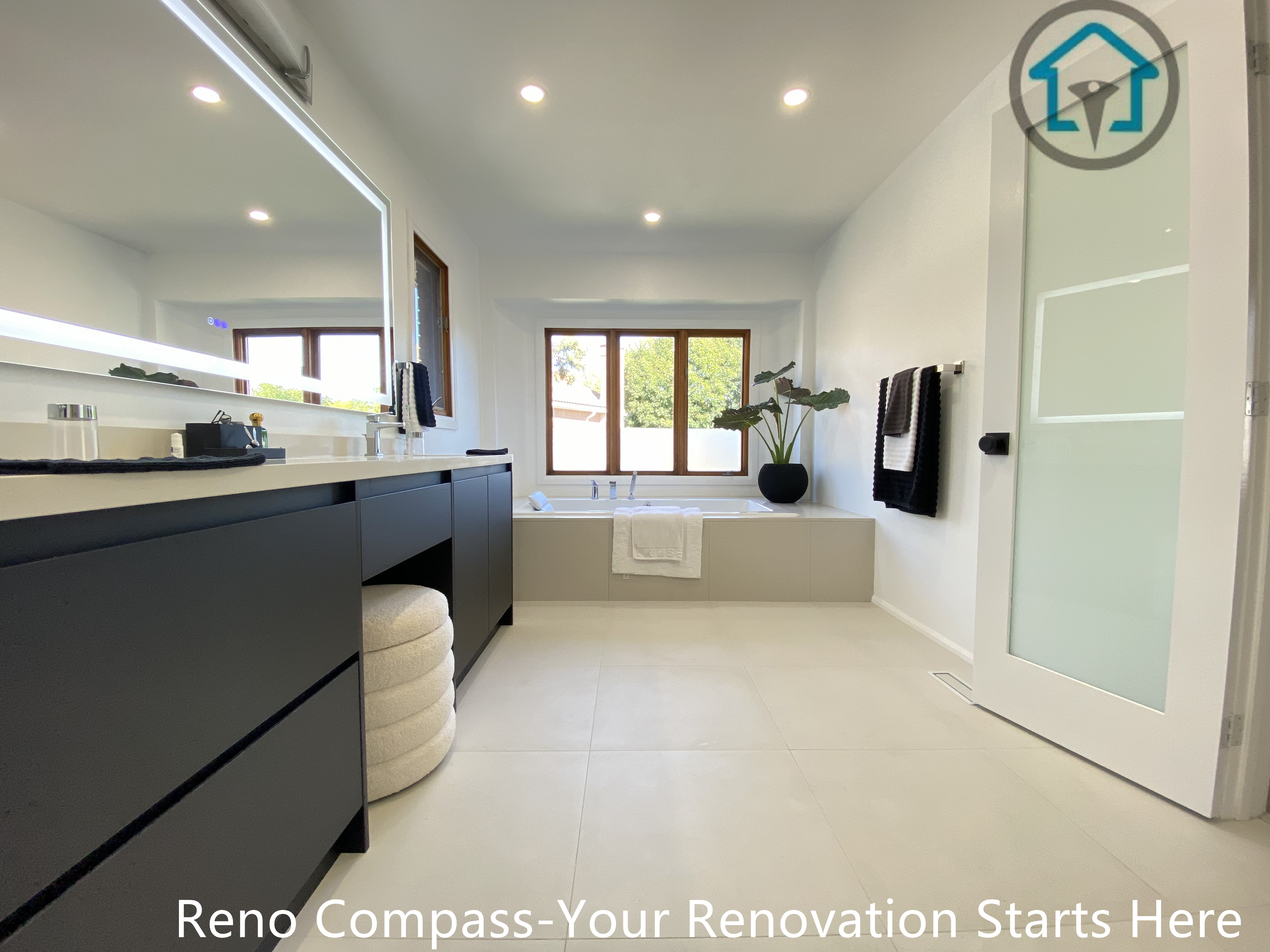 Modern bathroom renovation in Brampton featuring a built-in soaking bathtub, clean-lined surround, and large window bringing in natural daylight. The design emphasizes relaxation, simplicity, and spatial balance, completed by a professional Toronto renovation company.