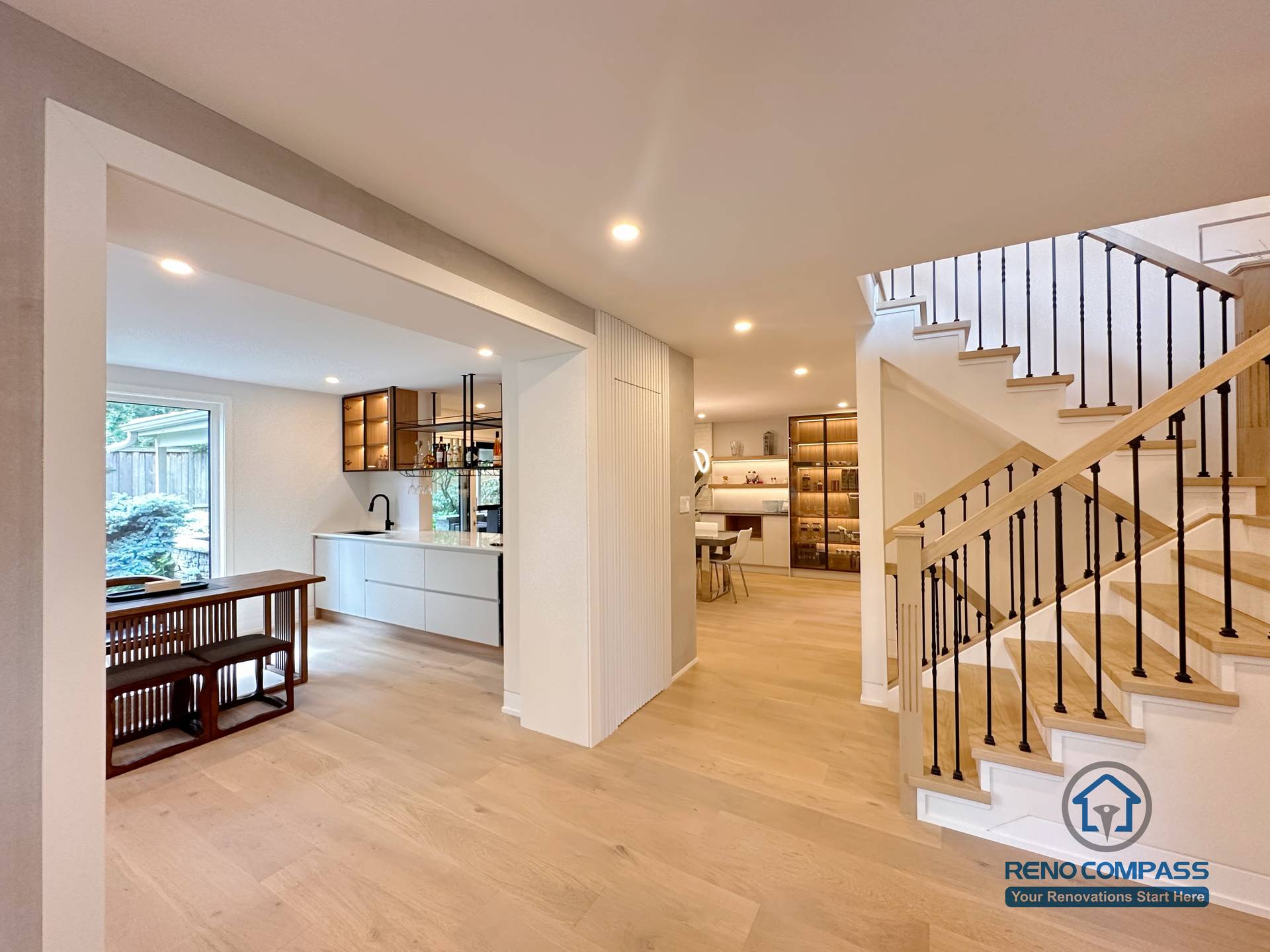 This Toronto flooring and stair renovation showcases a modern open-concept interior with light oak hardwood floors, custom staircase design, and seamless transitions between living, kitchen, and dining areas. The project highlights clean architectural lines, upgraded stair railings, and cohesive flooring installation that enhances natural light and spatial flow—ideal for contemporary home renovations in Toronto.