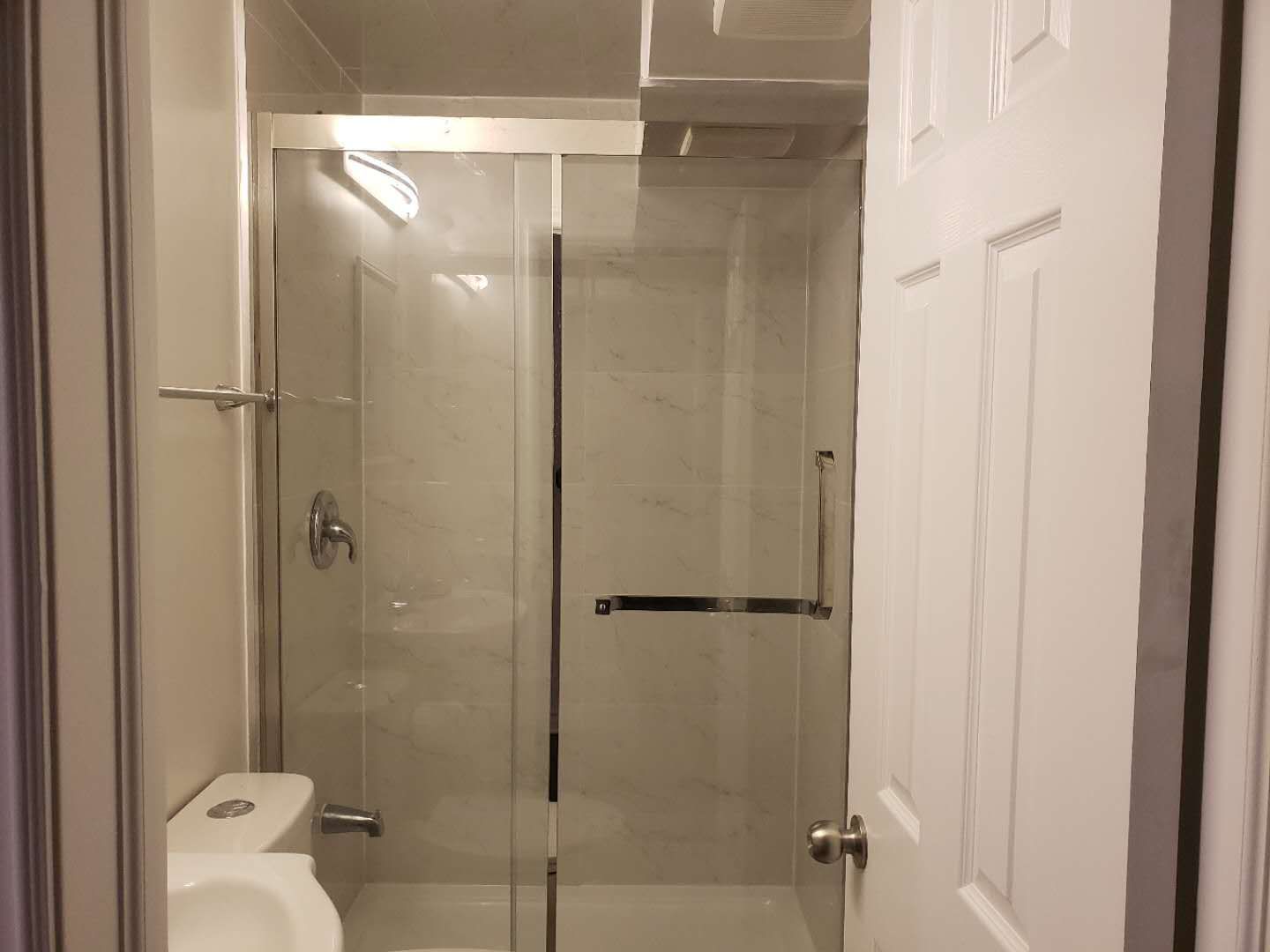 This Markham basement bathroom renovation features a modern glass-enclosed shower with clean tile finishes and updated plumbing fixtures. The space is designed for practicality and durability, incorporating a clear sliding glass door, neutral wall tiles, and efficient lighting to enhance brightness in the basement environment. Compact layout planning ensures comfortable use while maintaining a clean and contemporary look. This professionally completed basement bathroom highlights quality workmanship and thoughtful design, making it a functional addition to a fully finished basement in Markham.