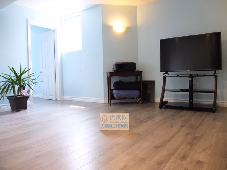 This interior renovation project in Richmond Hill features a bright and open living area finished with modern wood-look flooring and freshly painted walls. The updated lighting and clean layout improve natural light flow and make the space suitable for a family room, entertainment area, or multi-purpose living space. As part of a full interior renovation, this upgrade highlights functional planning and quality finishes delivered by a professional Toronto renovation company serving Richmond Hill homeowners.