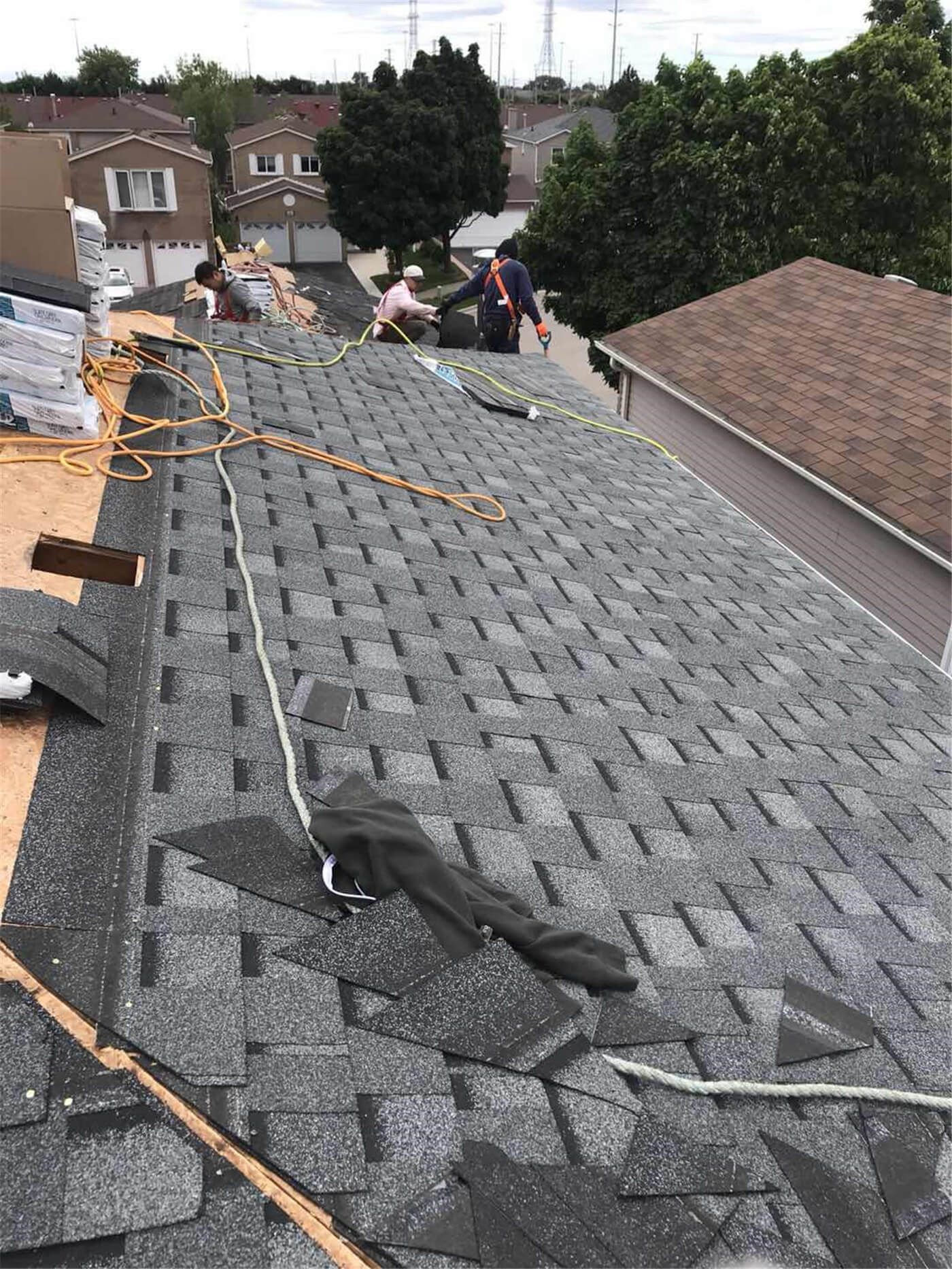 This image features the completed result of a residential roof replacement project in Toronto, showcasing newly installed asphalt shingles with a clean and uniform finish. The upgraded roofing system includes proper ventilation components and carefully aligned shingle placement to ensure long-term durability and protection against Toronto’s changing weather conditions. The project focuses on improving structural reliability, waterproof performance, and overall exterior appearance. Installed by a professional Toronto roofing and renovation team, the new roof enhances curb appeal while providing dependable, energy-efficient protection for the home throughout all seasons.