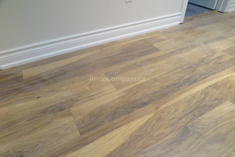 Close-up view of hardwood flooring installation during a North York interior renovation project. The image showcases clean plank alignment, natural wood grain texture, and precise baseboard finishing completed by a professional Toronto renovation company, emphasizing craftsmanship, durability, and high-quality interior flooring work.