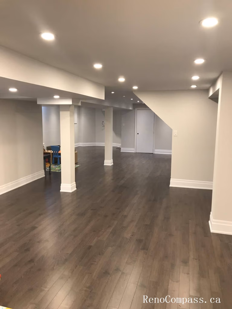 Richmond Hill basement renovation featuring a spacious open-concept layout with new hardwood flooring, recessed LED lighting, and upgraded structural finishing. This professionally finished basement enhances usable living space, comfort, and property value while maintaining a modern, clean interior design suitable for family use and entertainment.