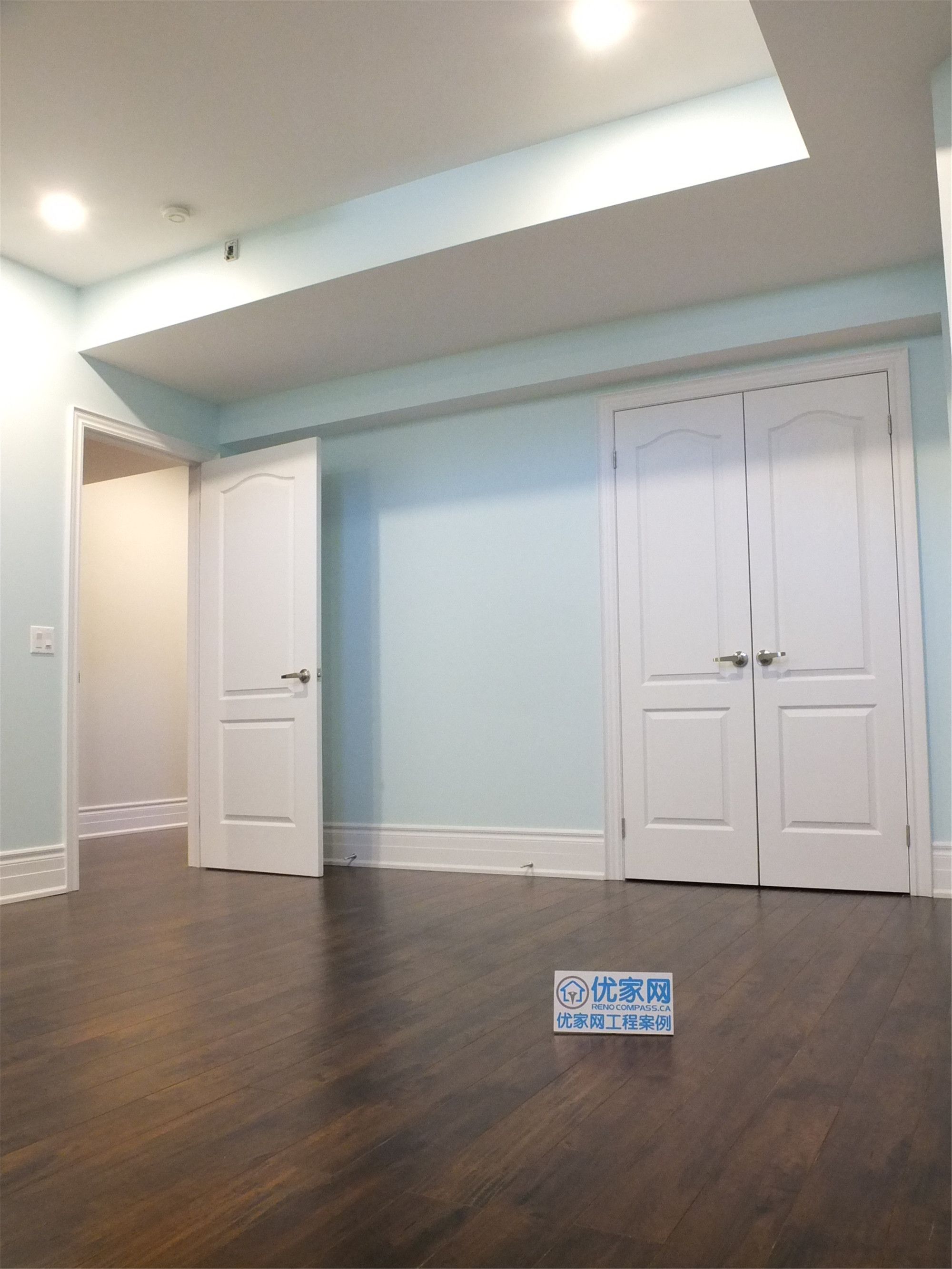 This Richmond Hill basement renovation features a finished bedroom with built-in closet storage, smooth wall finishes, and dark hardwood flooring. The space is designed for comfort and functionality, making it ideal for a guest room, home office, or rental basement unit.